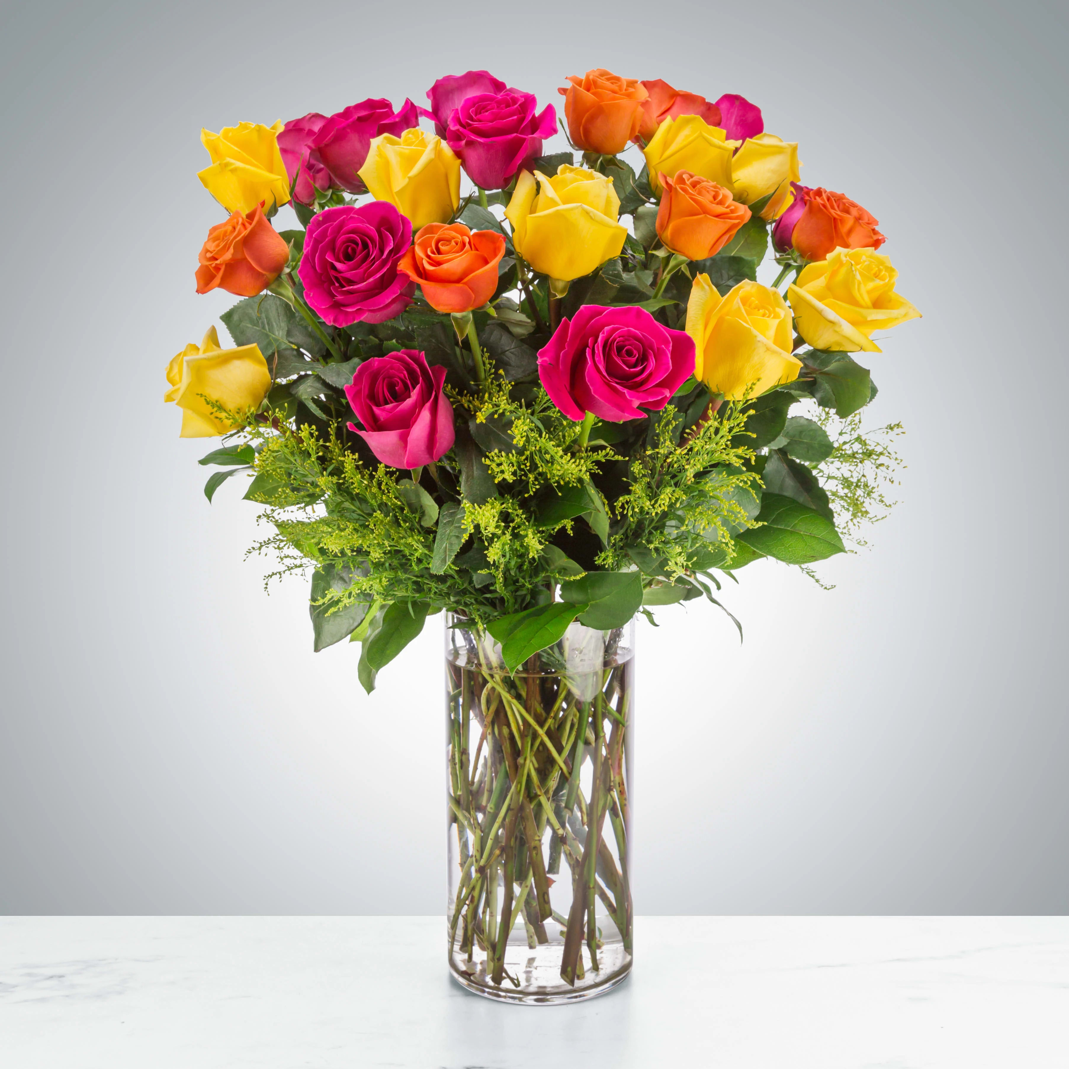 The Sound of Joy by BloomNation™ - 2 Dozen Yellow, Orange and Hot Pink Roses. Send an explosion of color with this long-stemmed rose arrangement. A great alternative to the classic red rose, send a giant arrangement of multicolored bright roses.  Approximate Dimensions: 20''D x 28&quot;&quot;H