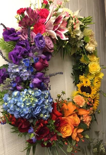 Rainbow Garden Celebration of Life Wreath - A Rainbow of color to celebrate your loved one's life. Flowers may differ slightly different seasons of the year, but the overall look and colors will shine bright.