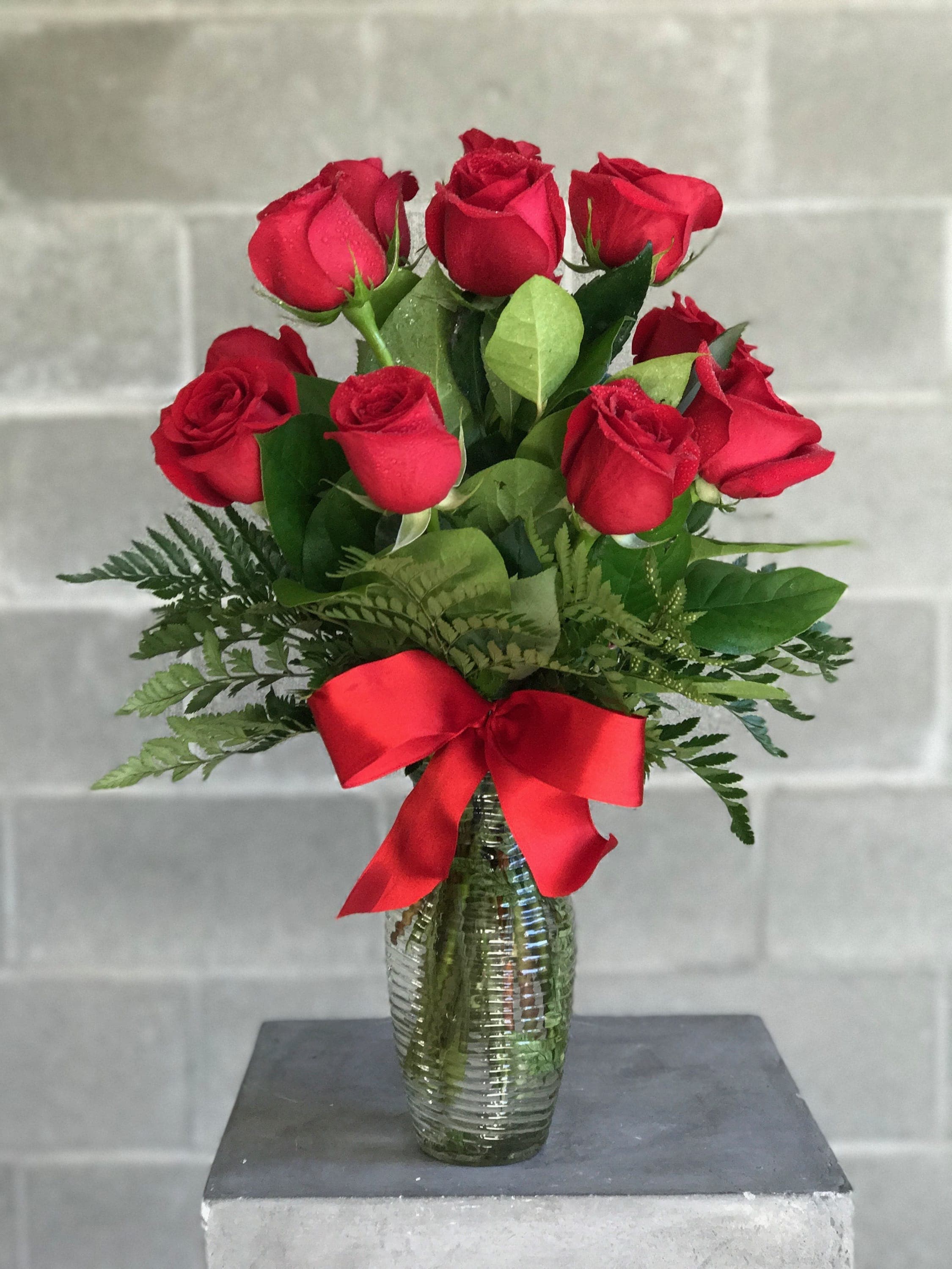 Dozen Rose Special - LIMITED TIME OFFER     We are offering gorgeous red roses for an amazing price!      Order yours today before it's too late!      What's Included?  One Dozen Red Roses Glass Vase Red Ribbon Seasonal Greens