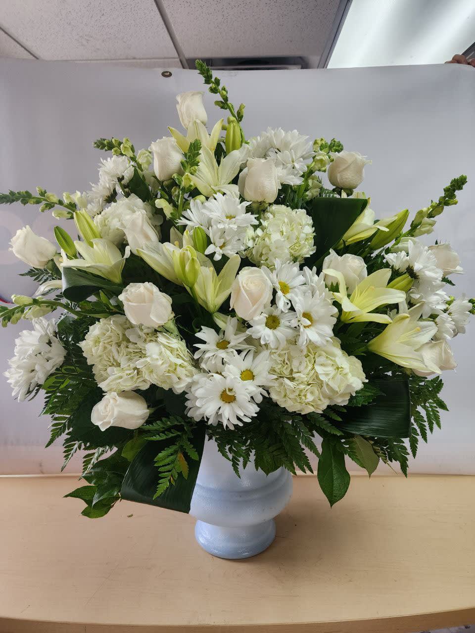 All White All White - nice arrangement with 11 white roses, 4 white hydrangeas,7white snap dragon, 7 white daisies 4 white Asiatic lily with greeneries in a white plastic container,