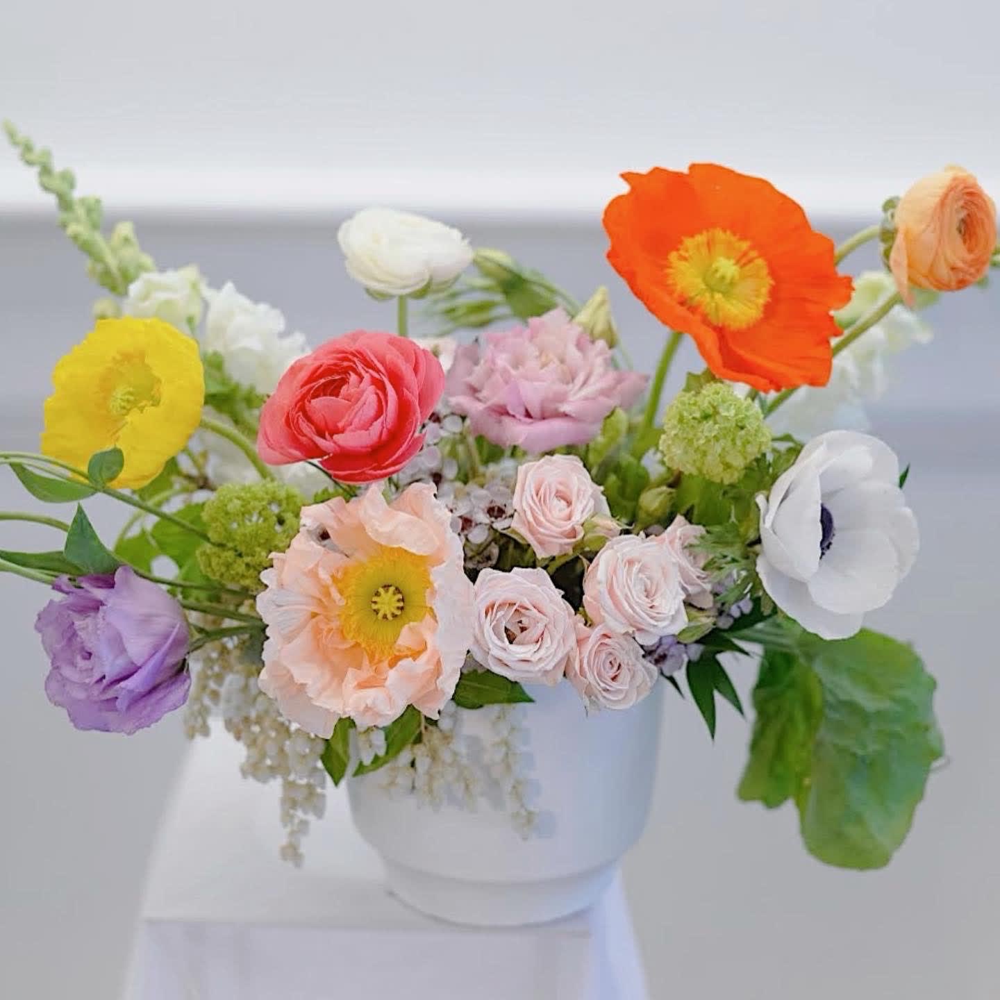 Spring Garden - Spring flowers hand selected by our designers to give you the absolute best of the season. Arranged in a keepsake pot or planter, in a natural and free-flowing style to mimic the most exquisite botanical gardens. Every arrangement will be completely unique, but it will be designed in the style shown, with punchy colors and a mix of blooms.  The blooms used may vary by the season and availability, and since each arrangement is custom-made to order by our talented designers, they will all look slightly different, which is what makes them so special!  The photo is a representation of the overall vibe of this Botanique signature arrangement. 