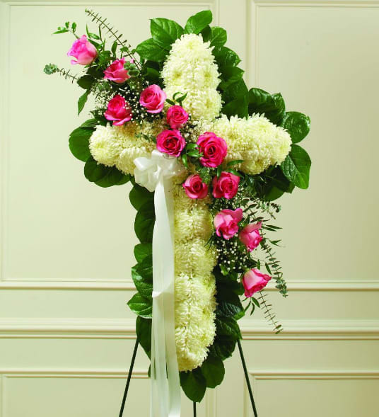 Pink &amp; White Sympathy Cross - Our Pink &amp; White Sympathy Cross is a beautiful tribute to celebrate a life of love of faith. Fresh white blooms create the cross while a pink rose sash serves as a feminine accent. It is a memorable piece that will lend comfort during a difficult time.