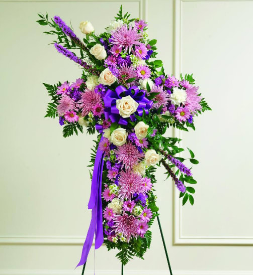 Lavender Sympathy Cross - Our Lavender Sympathy Cross is a beautiful tribute to a life of love and faith. Fresh lavender blooms are arranged neatly to create the cross, while white roses drape elegantly across the center. It is a symbolic piece that will exude your most genuine support, faith and condolences. 