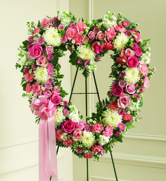 Pink &amp; White Sympathy Heart Wreath  - Our Pink &amp; White Sympathy Heart Wreath is a standing arrangement that is created to lend comfort during a difficult time. This lovely tribute features soft shades of pink and white flowers. It is a beautiful and feminine way to convey your most heartfelt condolences. 