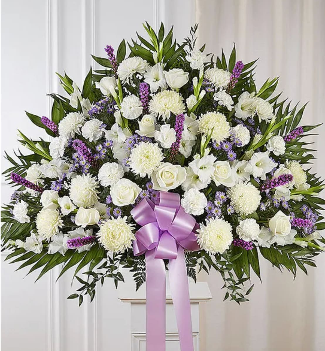 Heartfelt Sympathies Lavender &amp; White Standing Basket - One who has touched the lives of many deserves to be honored in a uniquely touching way. Our majestic standing basket arrangement in lavender and white is an impressive tribute to their memory. Artistically designed by expert florists with an abundance of soft, lavender-hued and white blooms, it is a heartfelt expression of your deepest sympathies.