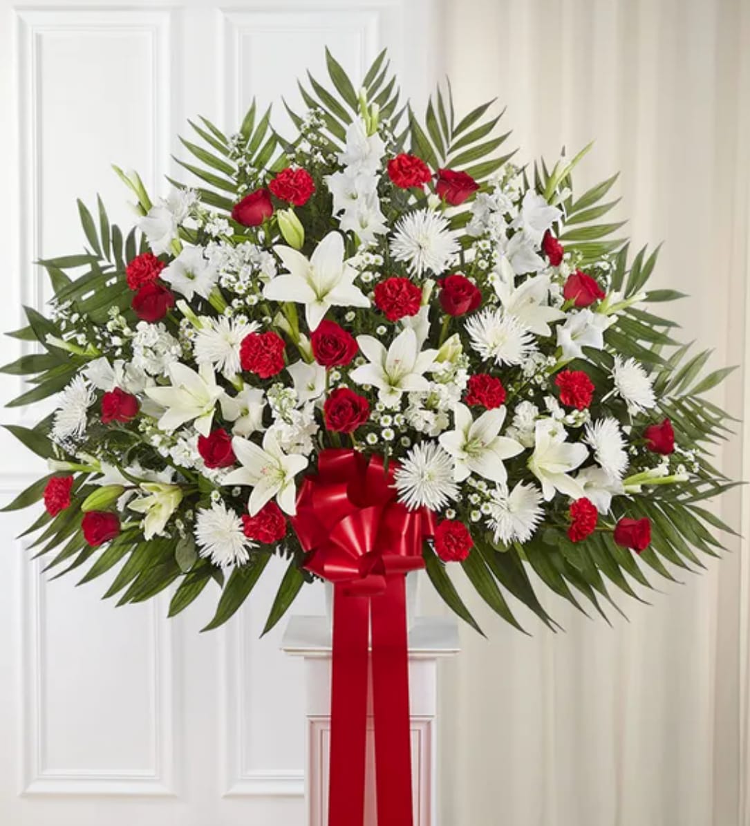 Heartfelt Sympathies™ Standing Basket- Red &amp; White - Love can help keep us going after a difficult loss. Sometimes this emotion is best expressed through a beautiful floral statement. Crafted by our expert florists, this traditional standing basket arrangement is filled with an array of red and white blooms, offering heartfelt condolences when words alone aren’t enough.