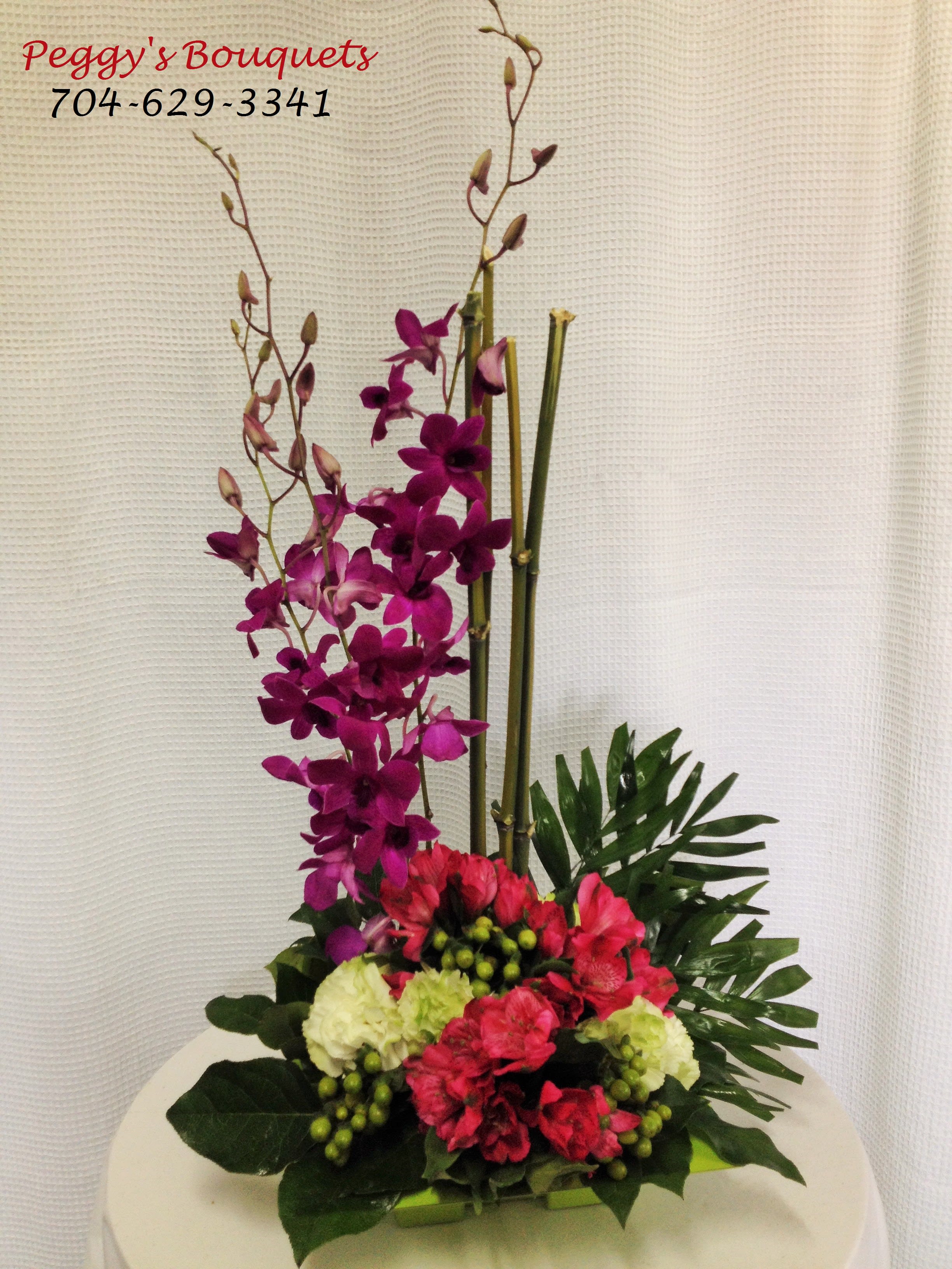 Orchid Delight - Orchids, altromeria, hypericum berries and more make this arrangement perfect for any occasion. Colors may vary. This is available year round. 