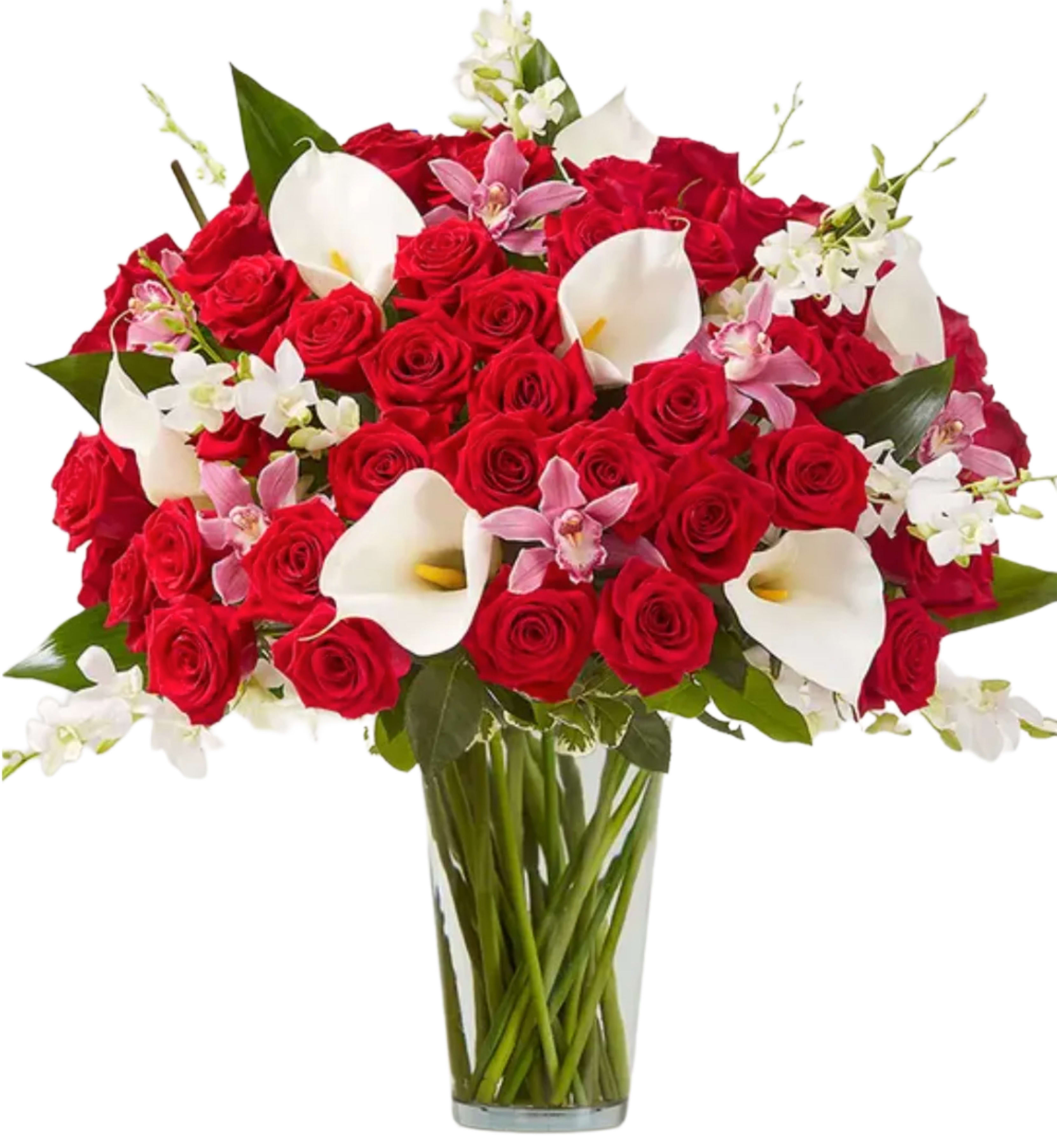 Elegant Extravagance™ Bouquet - The ultimate Valentine’s WOW gift! Our extravagant arrangement towers over two feet tall, featuring a gathering of roses, orchids and calla lilies in striking shades of red, pink and white. Accented by lush and textural greenery, it’s artistically designed in a clear glass vase to let the beauty of each bloom stand out. When it comes to surprising the one you love, this is truly the most unforgettable gift you can send. All-around arrangement with red roses; white calla lilies and Dendrobium orchids; pink cymbidium orchids; accented with aspidistra leaf and assorted greenery Artistically designed in a clear glass vase
