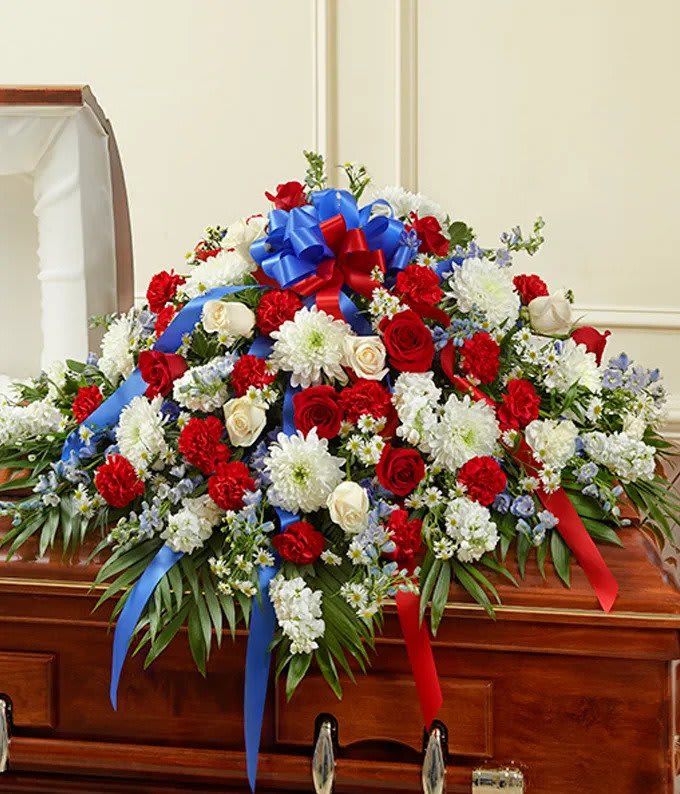 Distinguished Service Casket - A beautifully patriotic way to pay tribute to a loved one. This half-couch spray sends an eloquent message of strength, respect and freedom. 