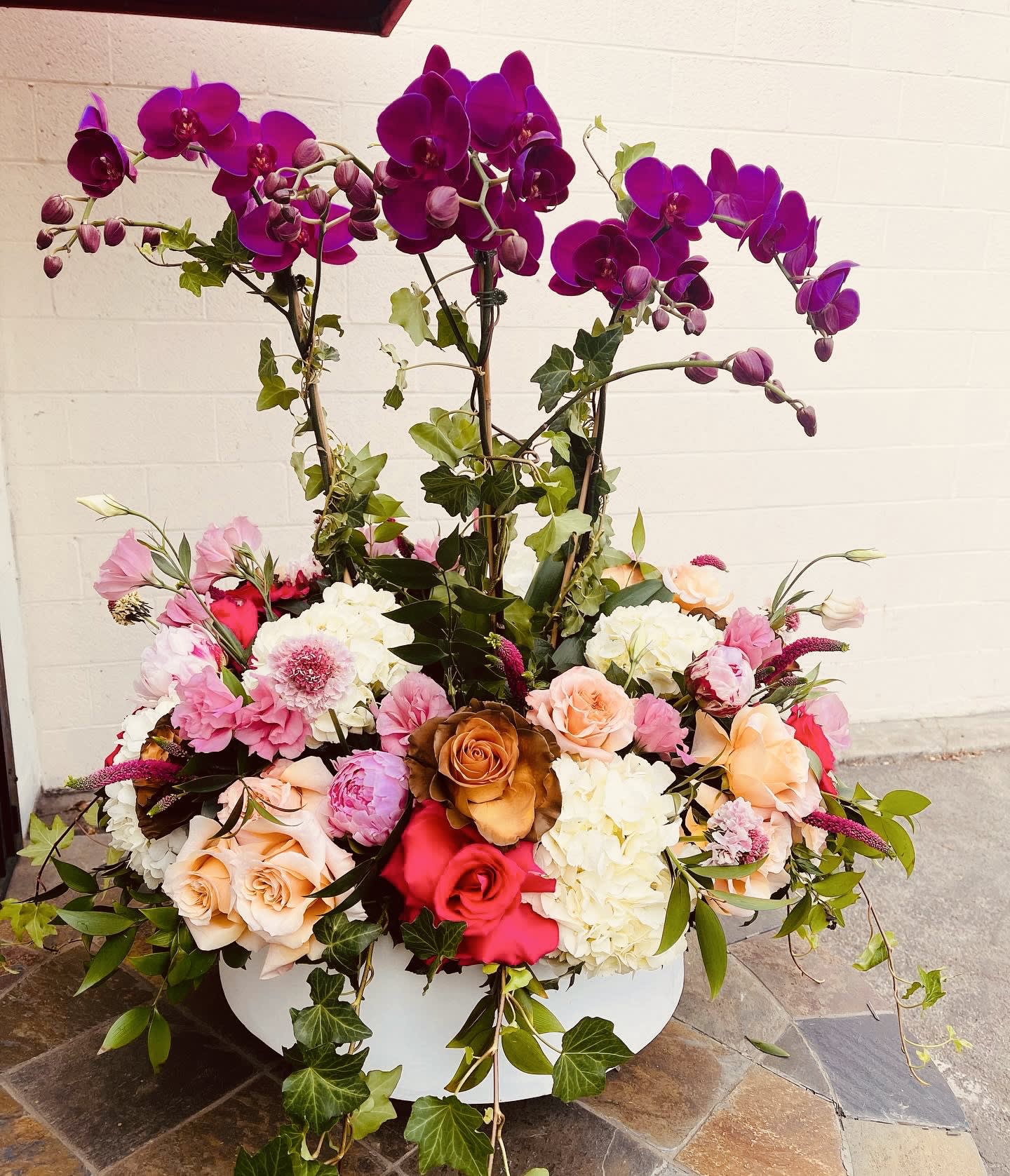 Large base with Orchid Plants - Large beautiful container with live orchids. Orchid plants  mixed with a beautiful lush of European important flowers. 