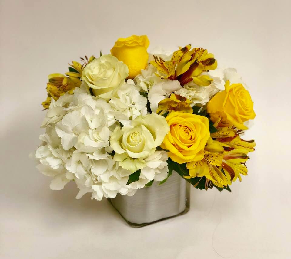 Just a Friendly Reminder - White Hydrangea are filled with cream and yellow roses, alstroemeria and eucalyptus in a silver wrapped cube.  Yellow roses are the color of friendship and these fresh blooms say, &quot;I'm reminding you that I'm here if you need a friend.&quot;