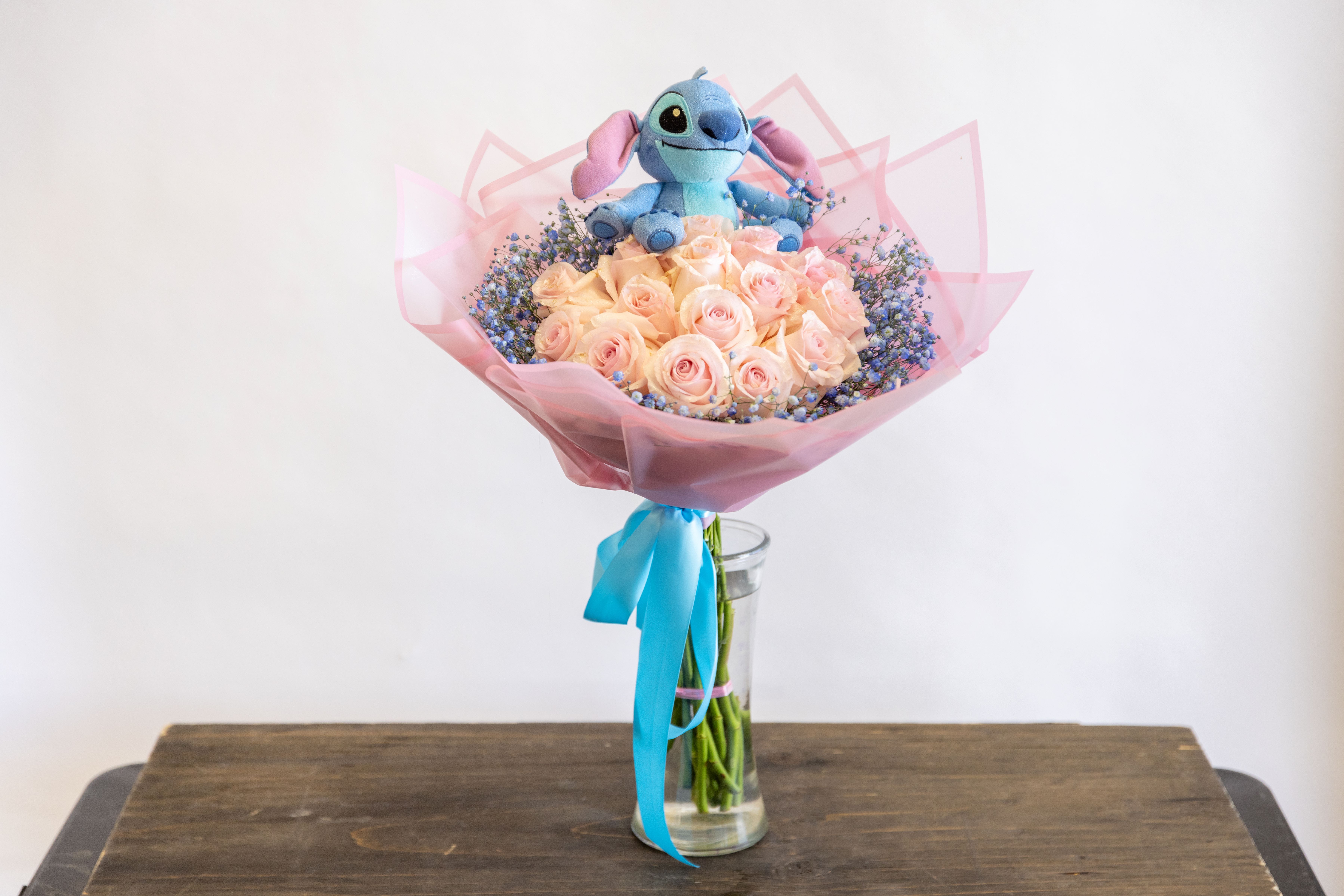 Blue Monster  - Two dozen roses in a ramo buchon style with a three inch plushie of a blue monster.