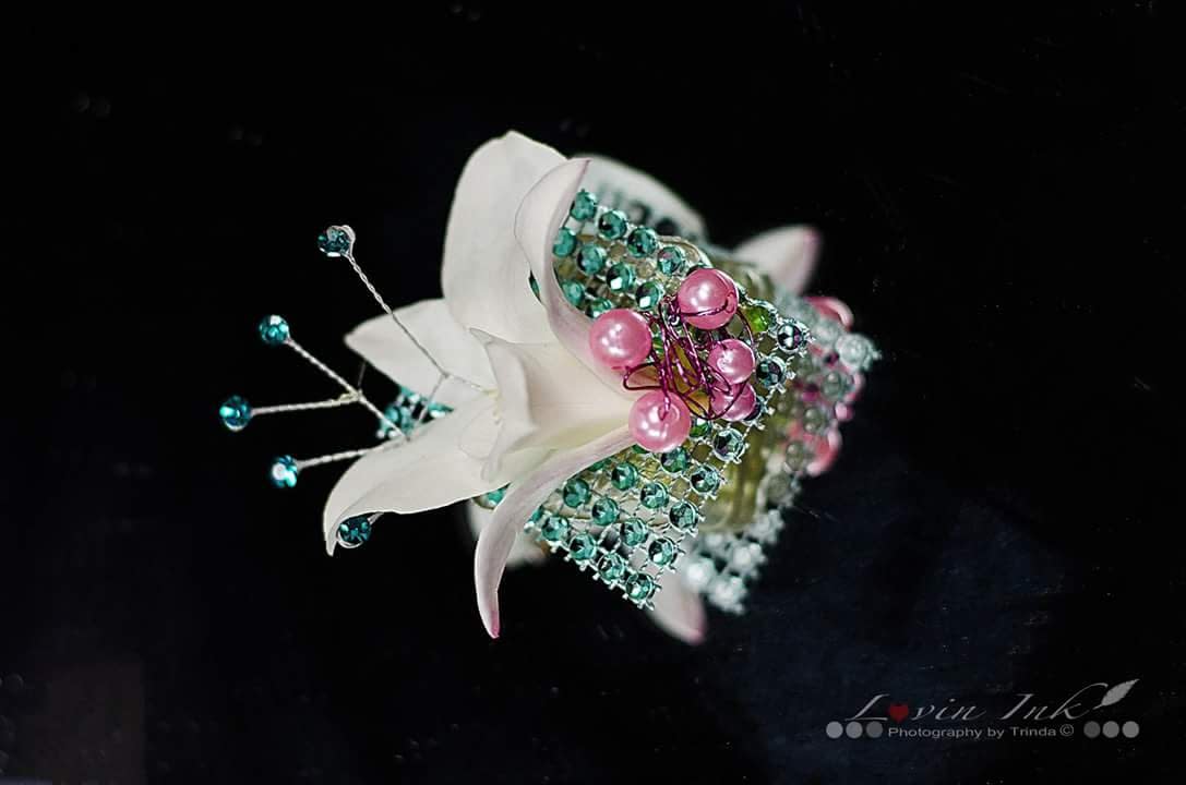 Orchid Boutonniere Orchid Boutonniere - white orchid on a piece of River of diamonds ribbon with jewels