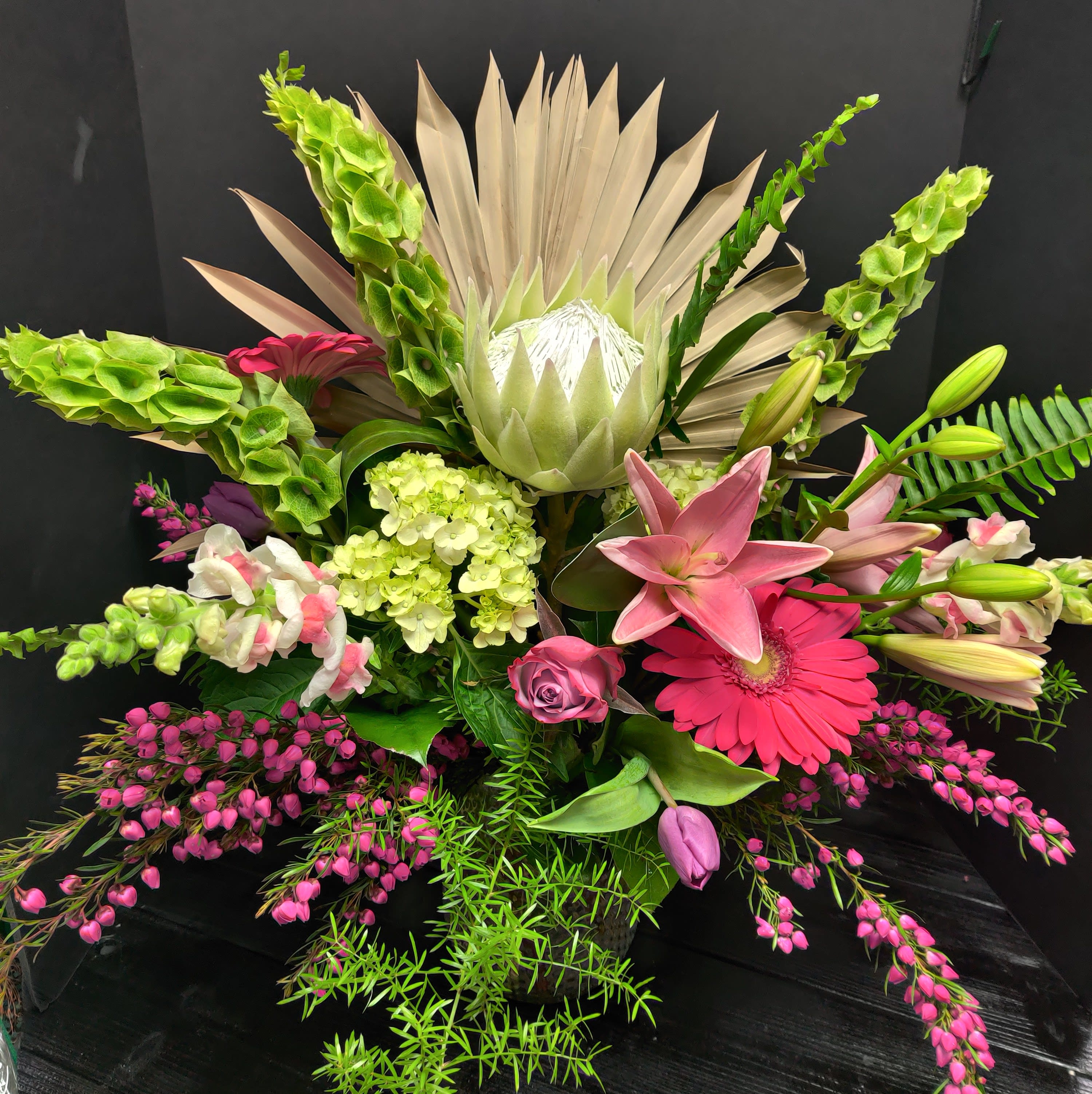 Mom's Everlasting Love - A beautiful arrangement of flowers to suit the best of mom's. With a faux protea in center .