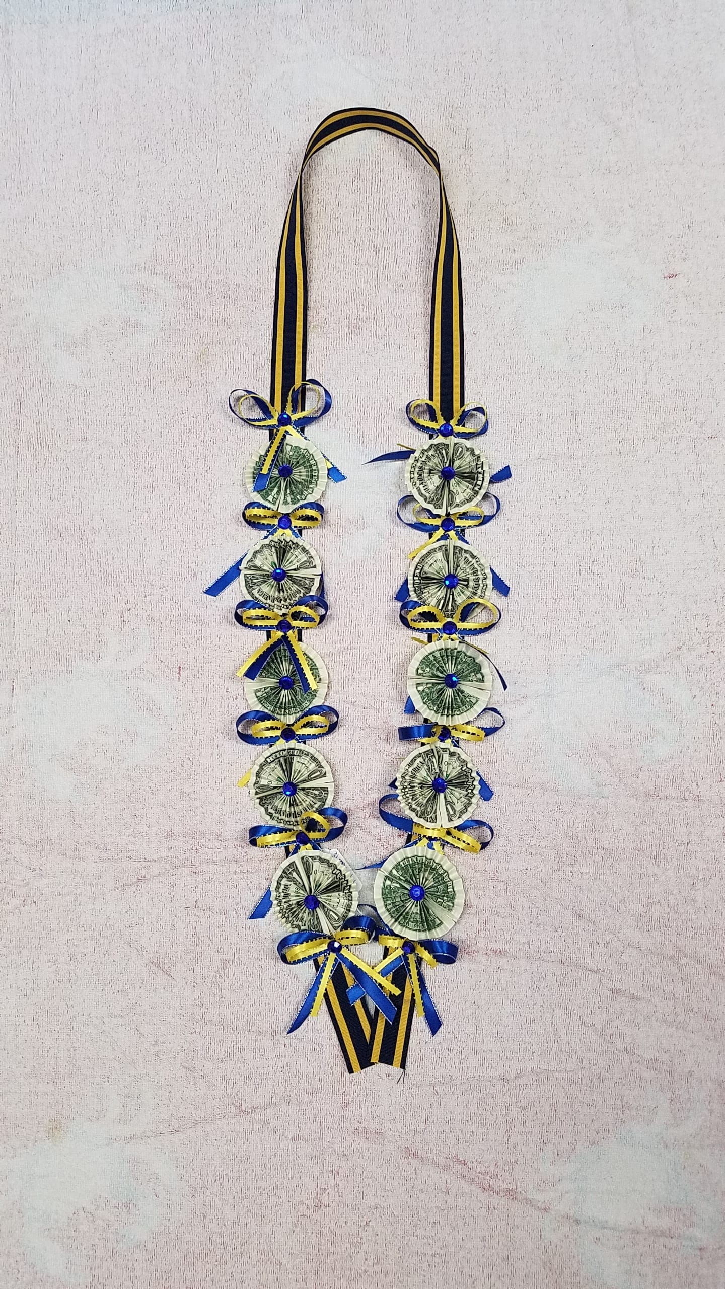 Money Lei #3 Money Lei #3 - (10 ) $1 bill attached to fabric lei (please call for color availability ) NO RETURN OR REFUND. ALL SALES ARE FINAL