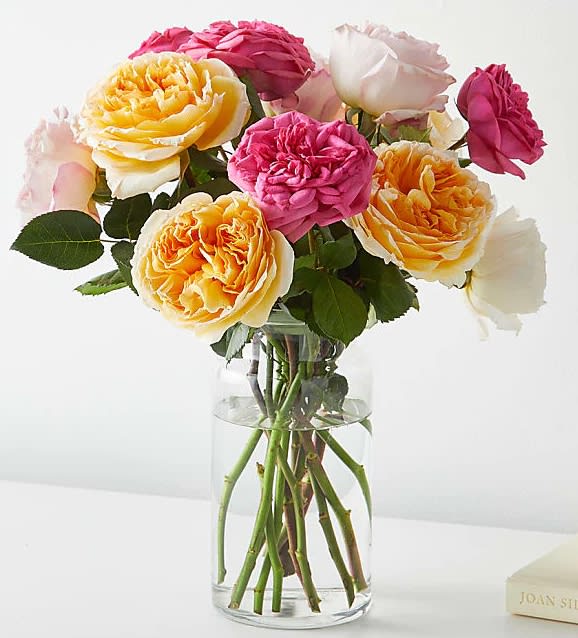  Mix Garden Roses Bouquet - Remind them to seize the day with this cheery arrangement of pink and yellow garden roses.A fabulous selection of our favourite garden roses, hand-tied with fresh skimmia and seasonal foliage. A relaxed and refined bouquet, our exquisite garden roses are given room to shine, flourishing in rippled perfection against a background of subtle, stylish greens.12 garden rose
