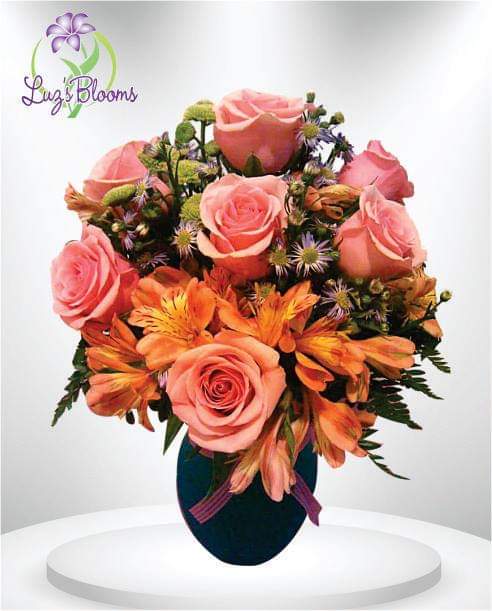 Garden Of Sunshine - Bright orange and peach colors make this arrangement perfect for all occasions.