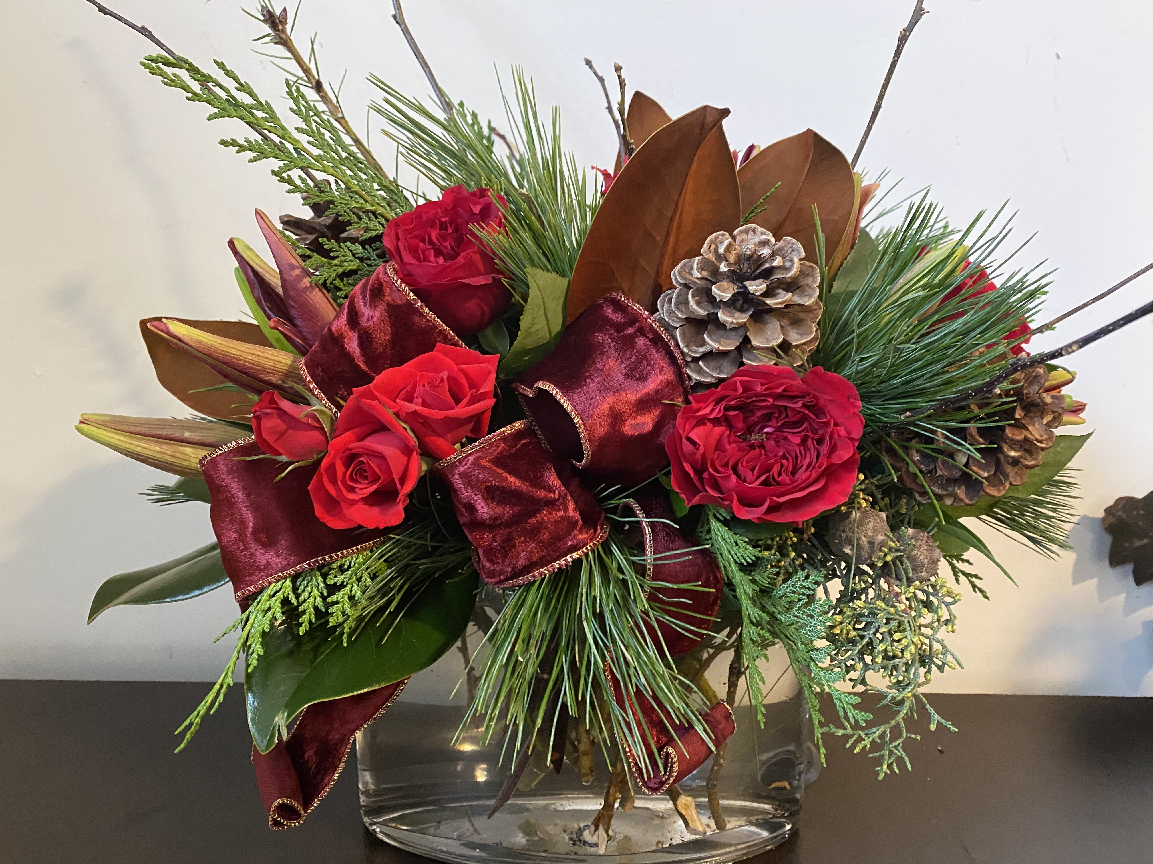 Noel - Vase filled with Holliday cheer,  garden roses, amaryllis, pinecones 