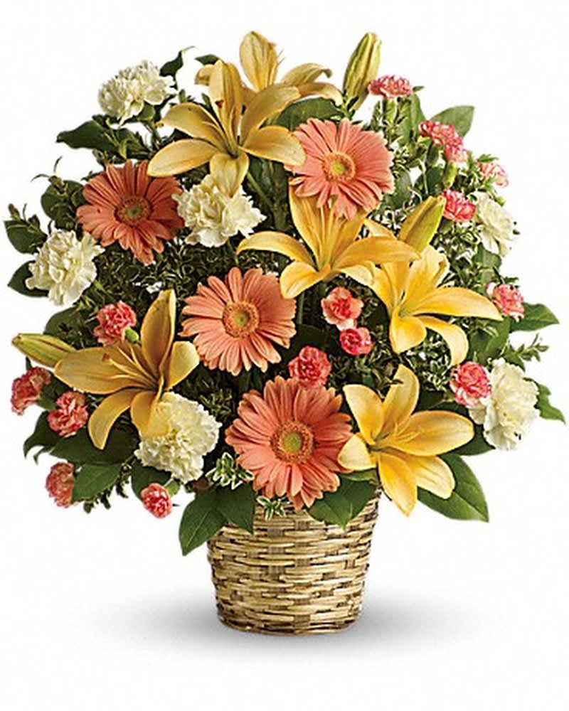 Soft Sentiments Bouquet - Bring warmth to the memorial service or home with this basket of sunshine. A radiant tribute to a bright, beautiful life, this bouquet of lilies, gerberas and carnations is a comforting reminder of your support and affection. This sentimental favorite features peach asiatic lilies, peach gerberas, creme carnations and minature orange carnations with fresh green oregonia and lemon leaf. Deilvered in a natural woven basket.