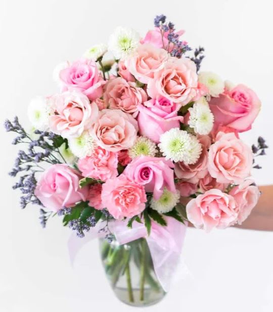 Mother's Day cotton candy color way bouquet - The Cotton Candy bouquet is the perfect arrangement to send to someone special in your life. It includes beautiful light pink and white roses; all beautifully arranged in a glass vase accented with a light pink bow. Valentine's day  Includes: • Pink Roses • White Roses • Mini Carnations • Green Poms • Clear Glass Vase with Bow