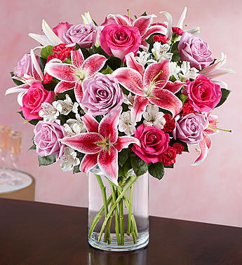 Everlasting Love - Let her know your love is everlasting with the timeless elegance of fresh blooms—like our eye-catching arrangement of roses and lilies in passionate hues of pink and purple