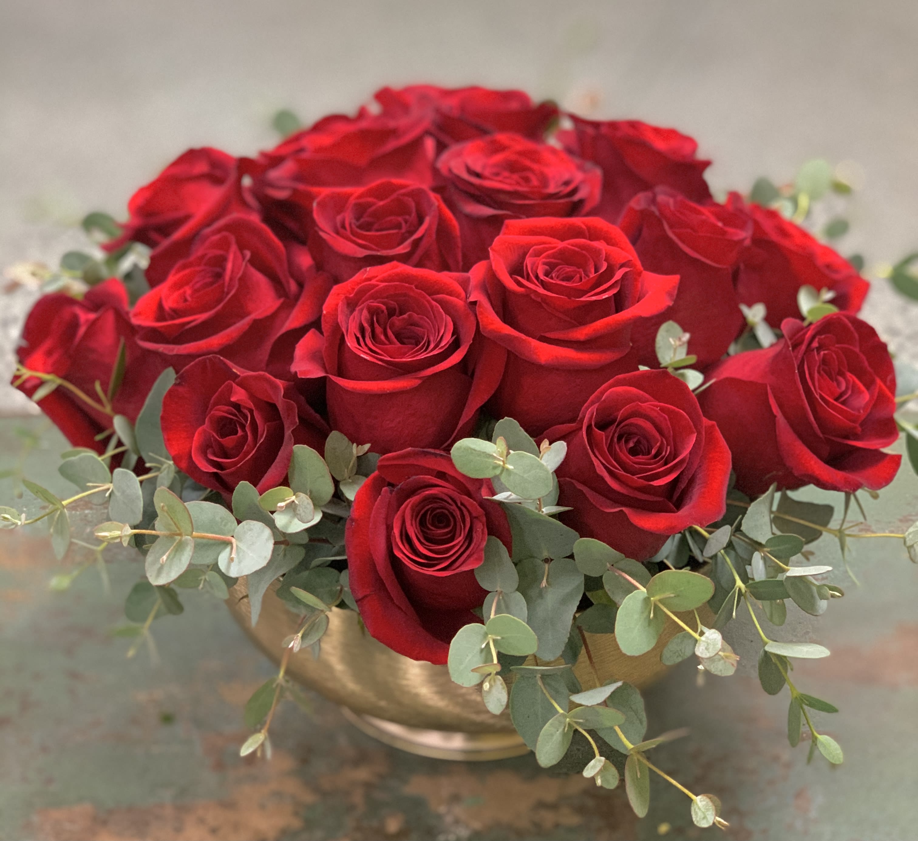 Isn’t it Romantic - Looking for romance? This brand new Valentine’s Day design is just the answer. Featuring 24 premium red roses artfully designed in a beautiful, gold pedestal container. Romantic and contemporary, this stunner will ensure a night to remember!