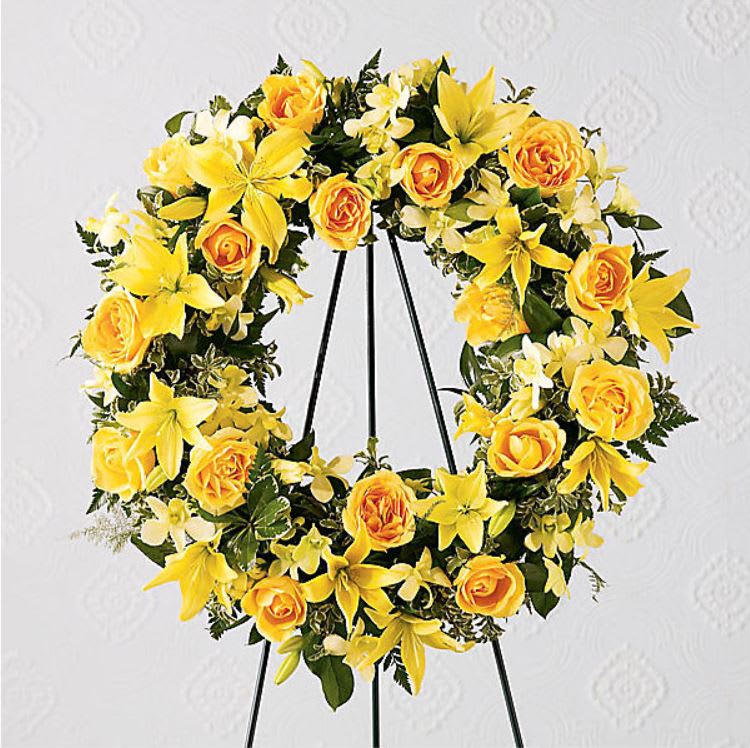 Ring Of Friendship Ring Of Friendship - The Ring of Friendship™ Wreath holds golden yellow roses, Asiatic lilies and dendrobium orchids against a background of assorted greenery. An expression of your friendship and sympathies.