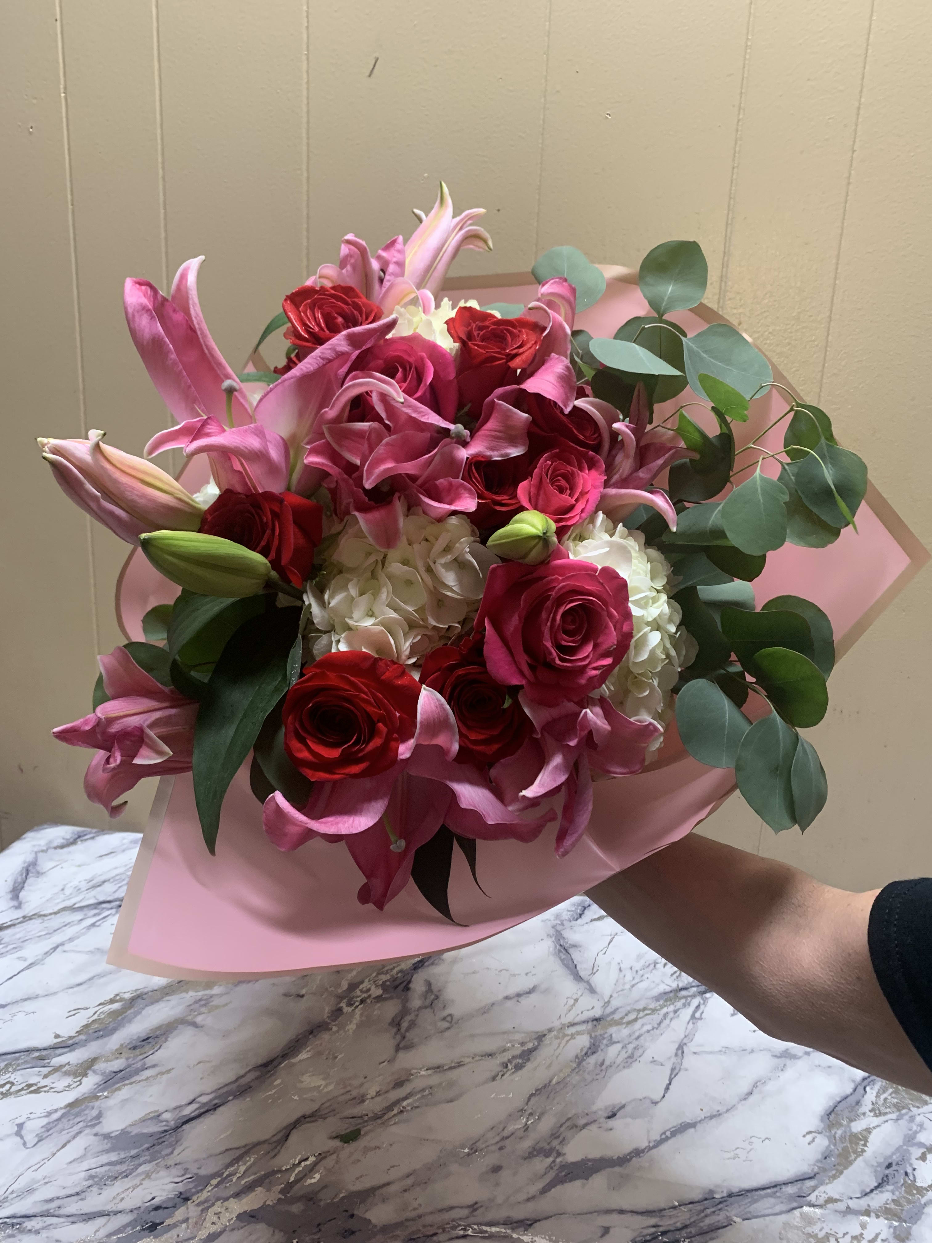Designers Choice Paper Wrapped Bouquet  - A beautiful hand held Bouquet designed in a custom bouquet arrangement, perfect if you are picking up. Please note if you have a choice of colors.
