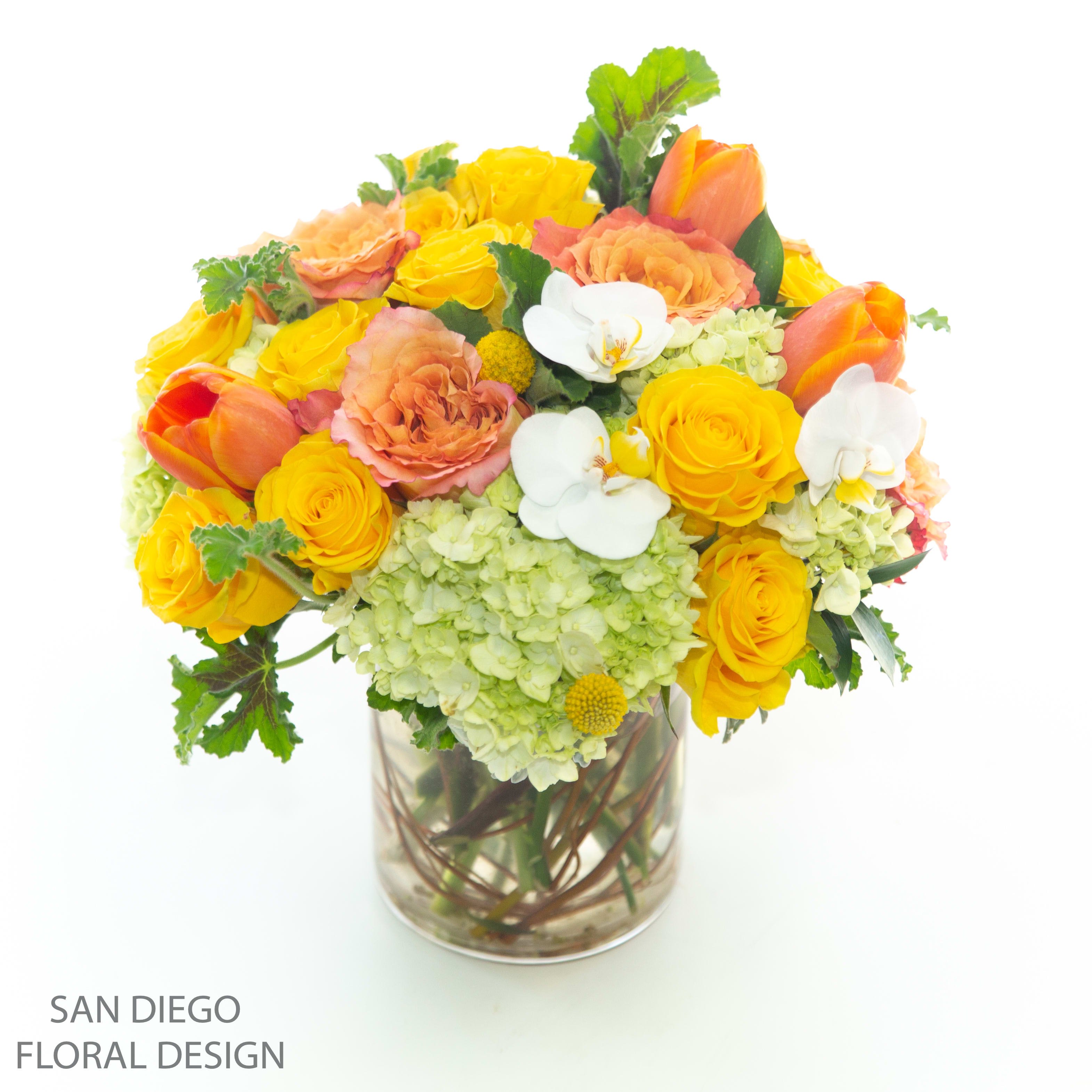 Sunshine vase  - Bright and cheery vase arrangement of yellow and orange roses, spray roses, green hydrangeas and orchids. 