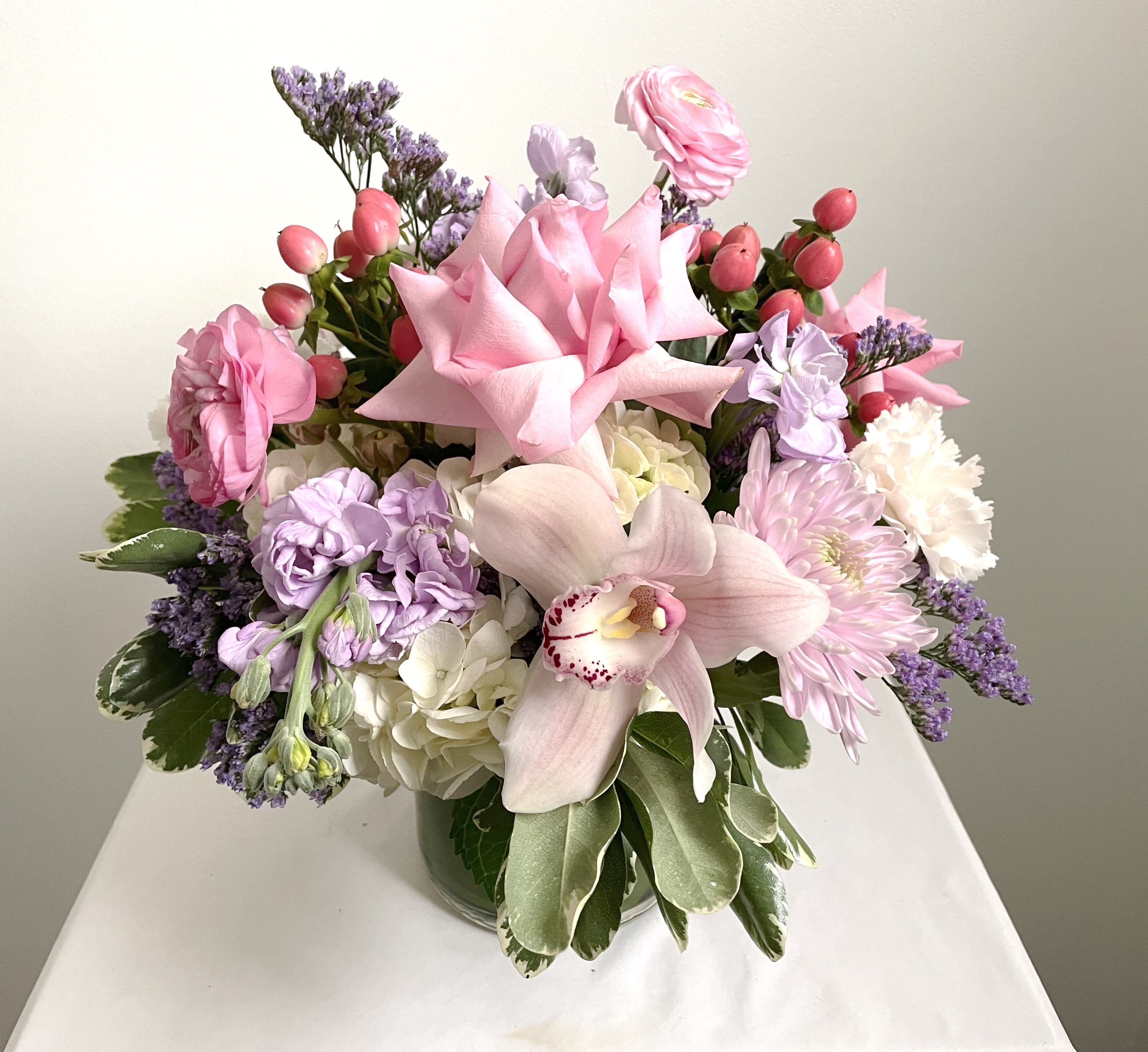 Mommy Dearest  - For the more complicated relationships.....impress your Mother with our Mommy Dearest Arrangement! With soft pink and purple flowers arranged in a glass cylinder vase with a ti leaf wrap.     Delivery Info- We make all of our deliveries after 1pm every day. If the weather is very cold, we prefer not to leave the flowers outside. Please let the recipient know that they should expect delivery.