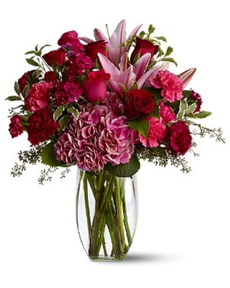 Burgundy Blush - Make a lovely lady blush with a generous mix of wine-hued blossoms such as roses, hydrangea, Asiatic lilies and more - in rich shades of burgundy, red and pink - delivered in a simple glass vase. With over half a dozen different varieties of flowers, it's a colorful and rare gift for any occasion. A mix of red, pink and burgundy flowers such as roses, Asiatic lilies, hydrangea, carnations and Sweet William â accented with greenery â is arranged in a clear glass vase. Approximately 17.5&quot; (W) x 19&quot; (H) Orientation: All-Around As Shown : TFWEB364