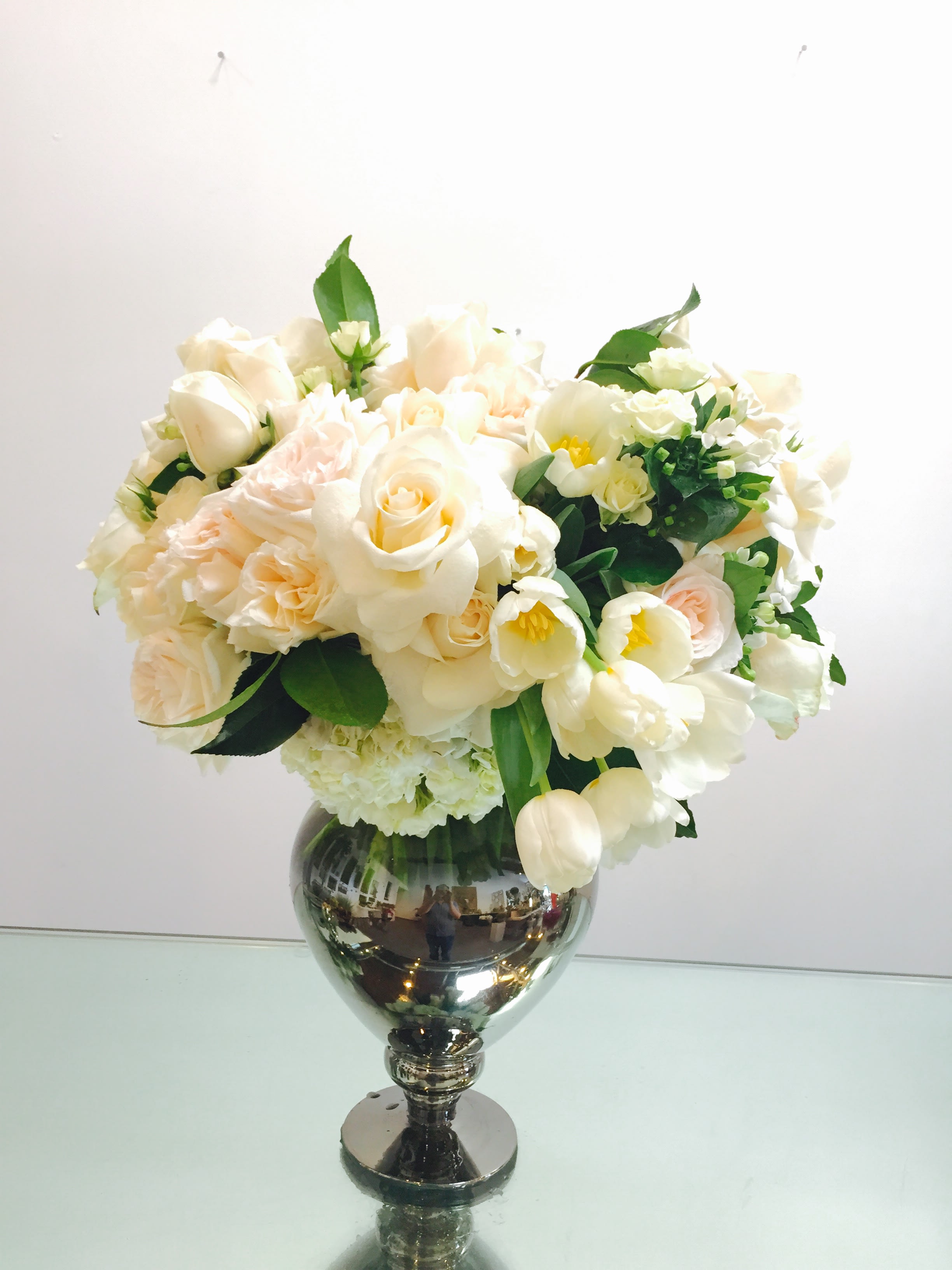 Fair Lady - A beautiful collection of varying shades of white blooms in a vintage vase.