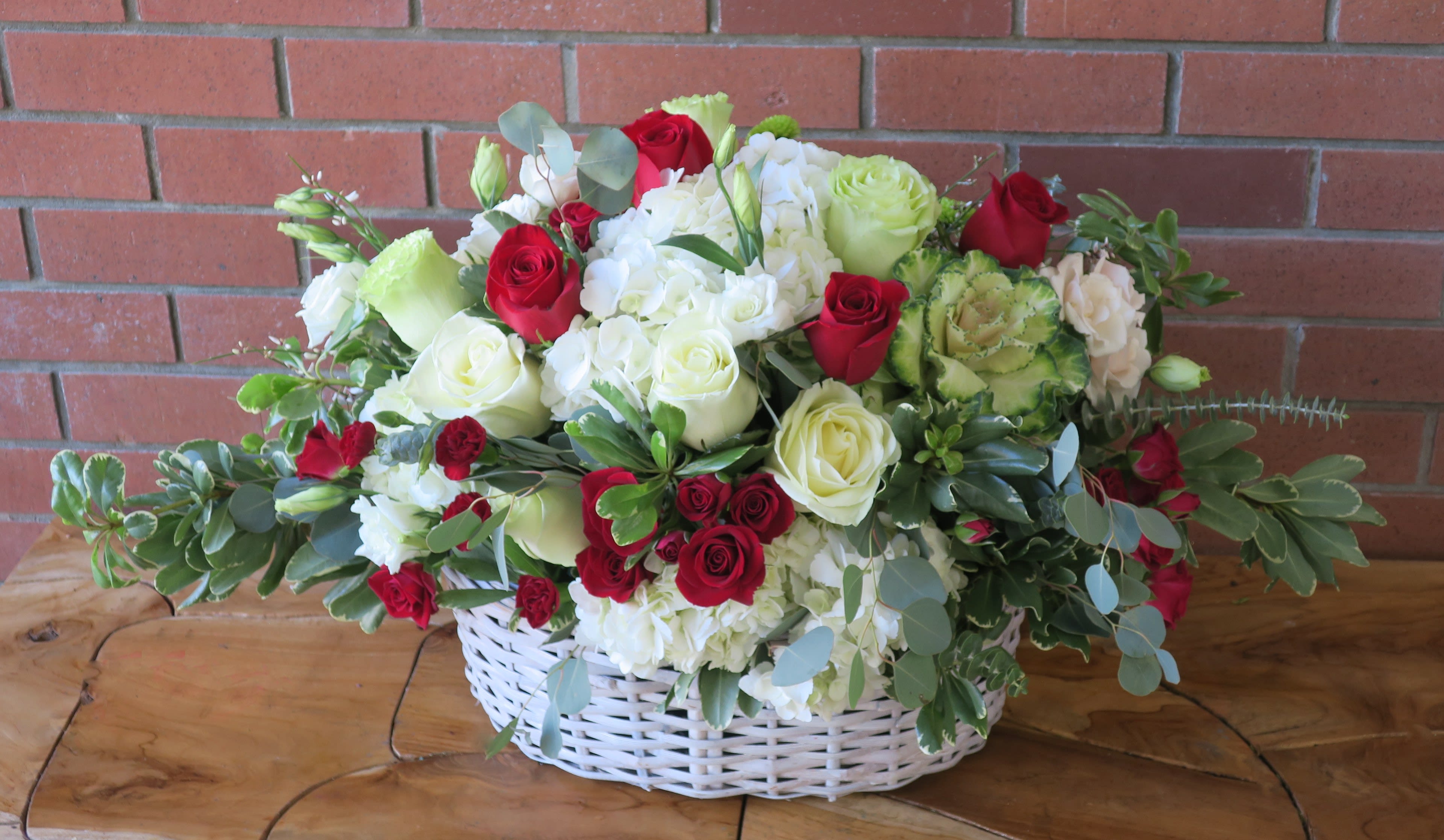 Sincerity Basket Of Blooms - Beautiful red roses, white hydrangeas, green and white roses with spray roses and lush fillers and flowers in a big white basket. 