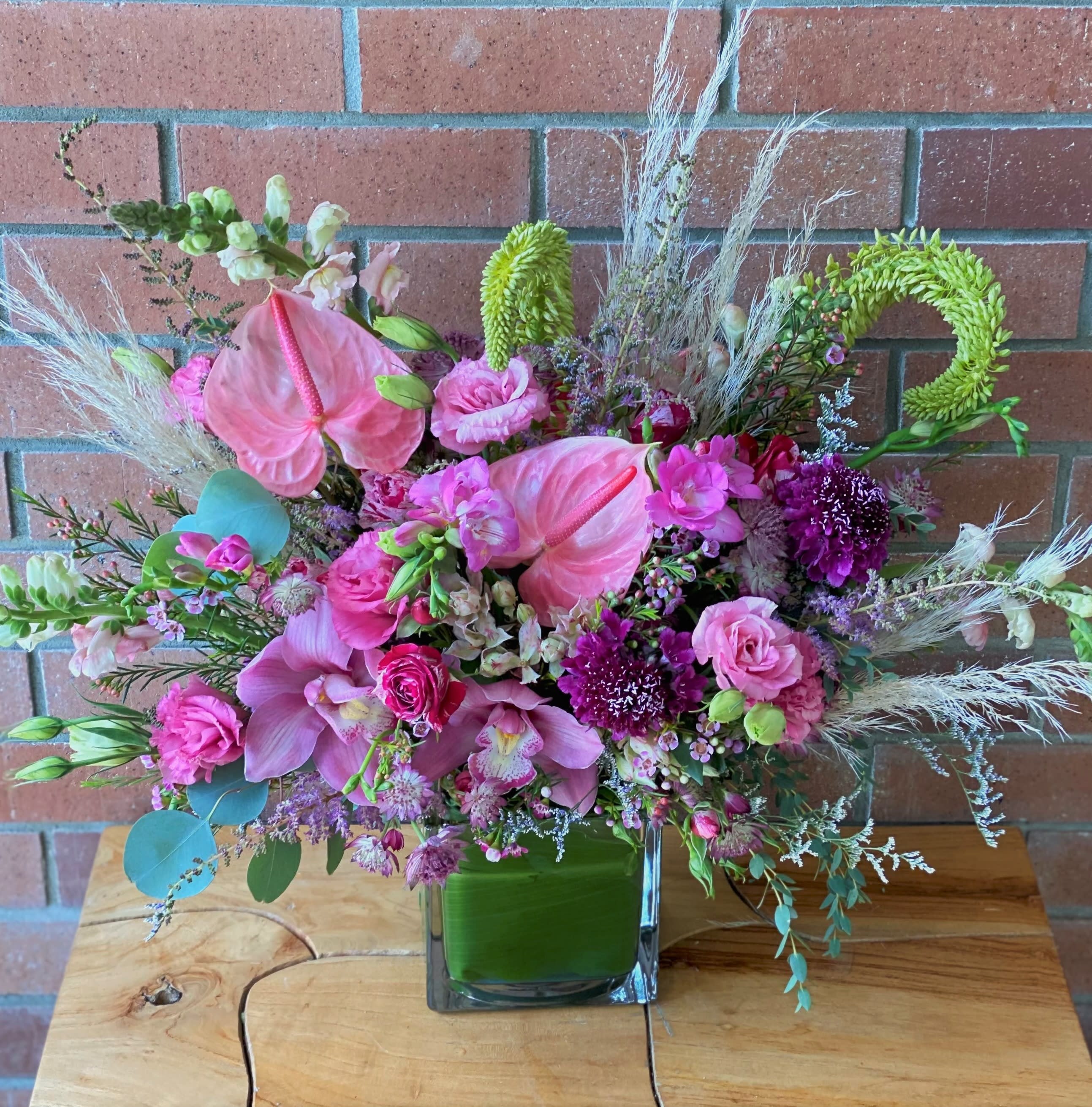 Blushing Blossoms Blushing Blossoms - This fabulous array of premium anthuriums, orchids, spray roses, lisianthus, snapdragons, scabiosa, freesias, astilbe, premium greens and eucalyptus is sure to make her blush.