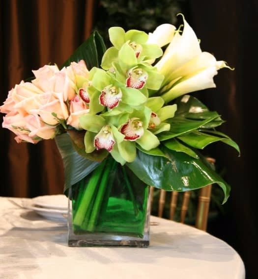 Flower Love - Gorgeous mini calla lilies, green orchids and pink roses accented with beautiful lush greens in a modern cube vase