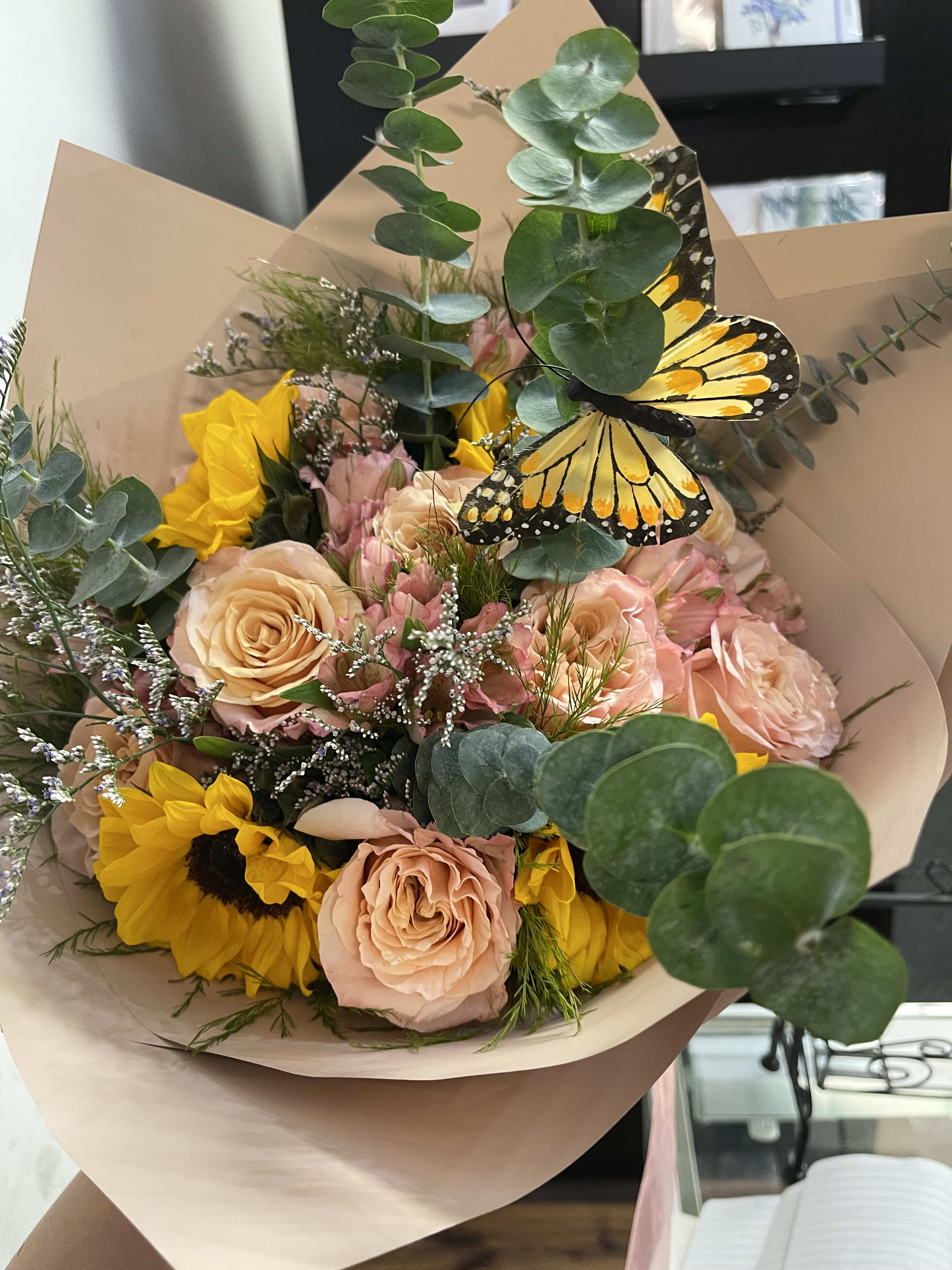 1 dozen roses with sunflowers and fillers 1 dozen roses with sunflowers and fillers - Korean wrapped bouquet filled with roses, sunflowers and fillers paired with butterflies