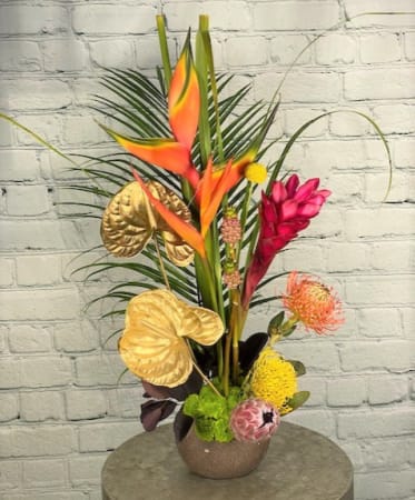 Golden Tropics - This gorgeous arrangement of tropical flowers is accented with gold anthurium.