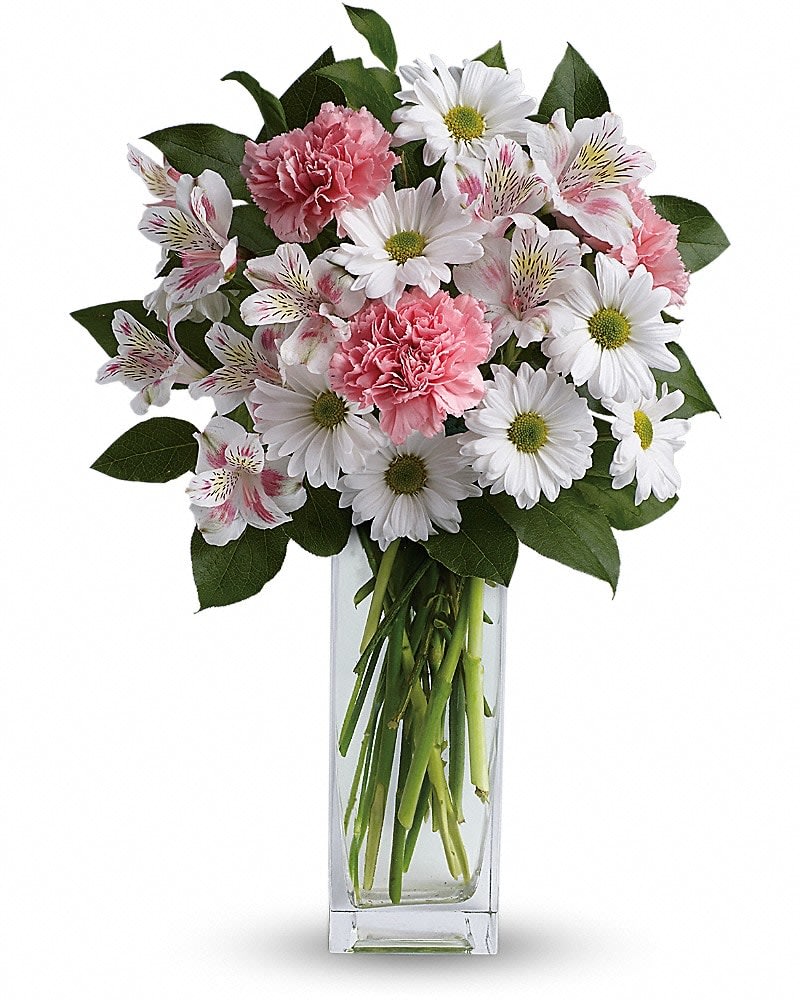 Sincerely Yours Bouquet by Teleflora - Soft and delicate, this pale pink and white bouquet speaks to the purity and simplicity of your adoration. This angelic bouquet includes soft pink carnations, light pink alstroemeria, white daisies and glossy green lemon leaf. Delivered in a Bunch vase.