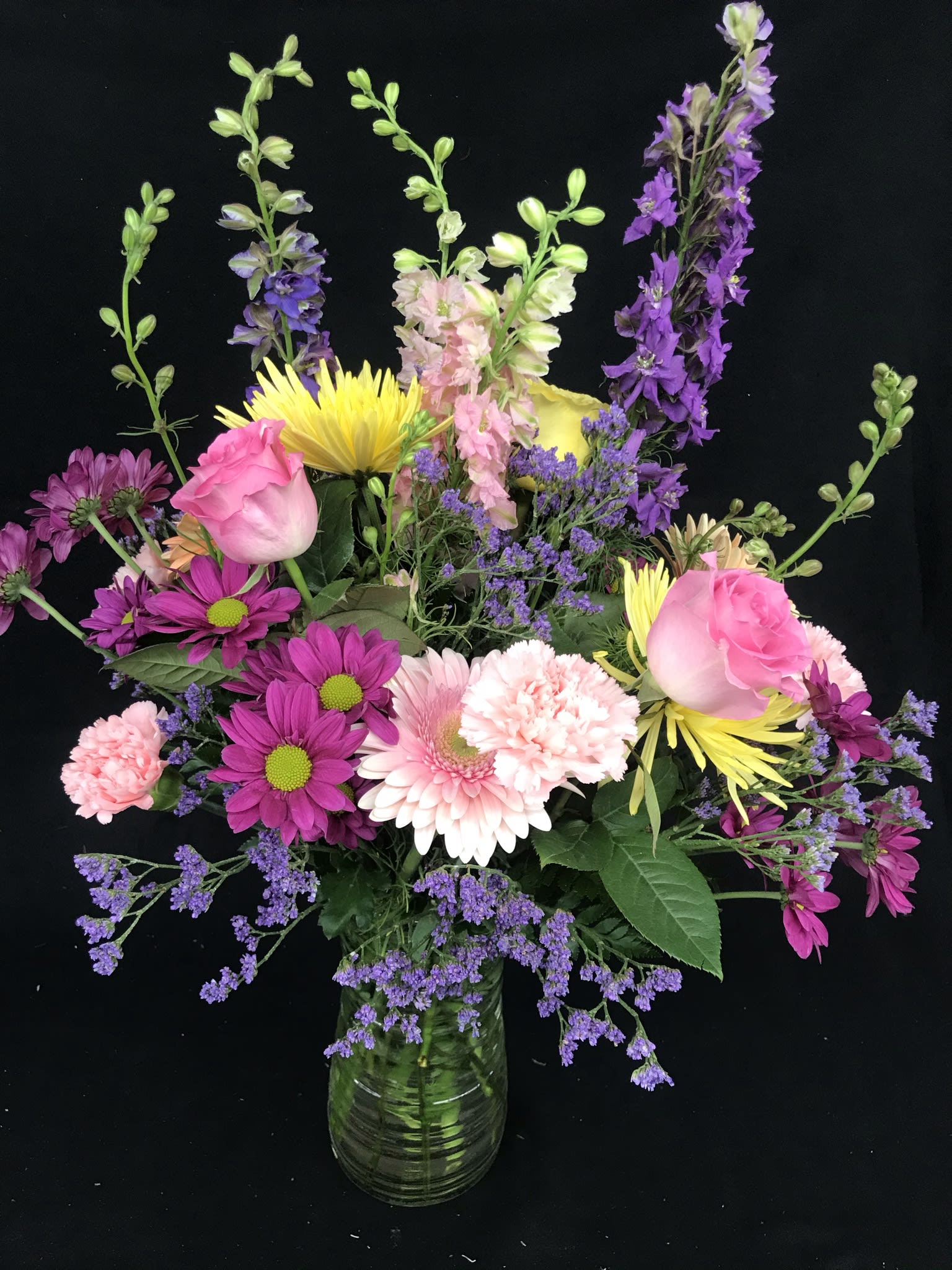  Romantic  Embrace Arrangement - This glass vase arrangement is filled with colorful assorted flowers 