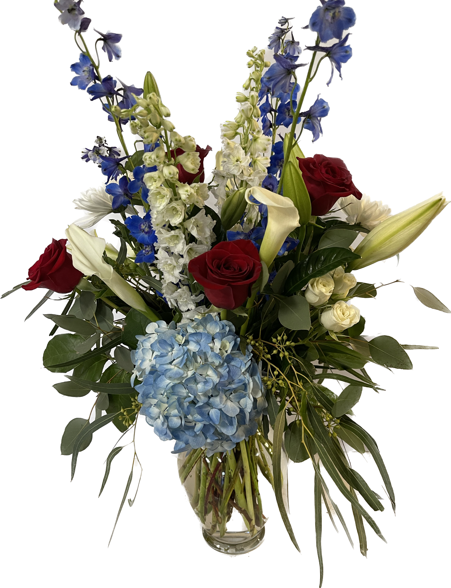 THE Red, White & Blue THE Red, White & Blue - Patriotic arrangement of red roses, white calla lilies, white & blue delphinium, blue hydrangea, white spray roses, white lilies and mums. Can also be ordered in a glass cube-request in "Florist instructions " at check out.