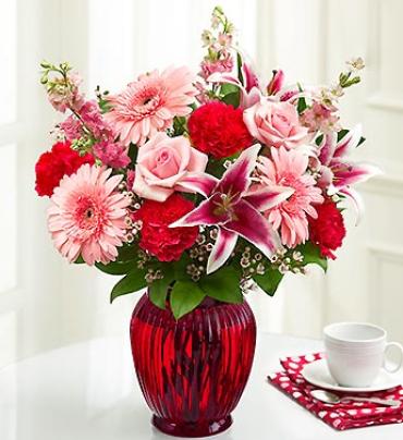 Blooming Treasures Blooming Treasures - If she loves the color pink, indulge her. This lush bouquet of fresh roses, lilies, Gerberas, carnations and more represents every shade of her favorite color. Hand-arranged in a vibrant red glass vase, it'll put her "in the pink" for certain. (Vase/Basket style may vary) Item # 91458