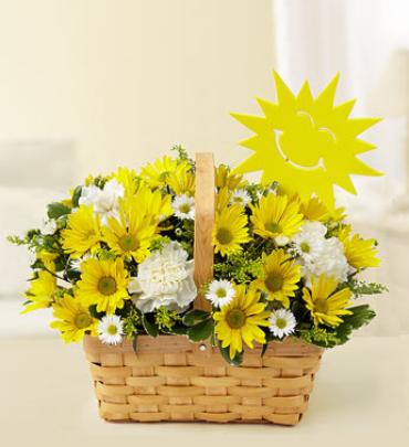 Basket of Sunshine -  Bring an instant ray of sunshine to their day. This hand-designed basket arrangement features a bright and abundant mix of beautiful poms, carnations, cremones, monte casino and more, accented with a smiling sun decoration for added happiness. (Vase/Basket style may vary)    Item # 90923 