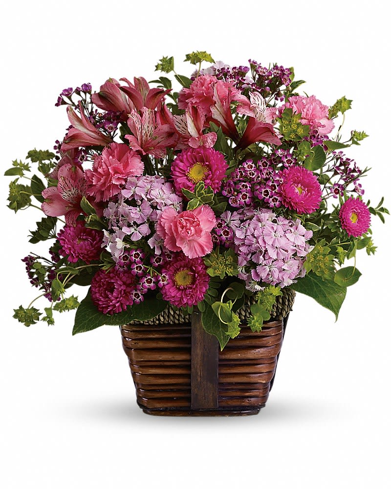 Happily Ever After - Send someone this delightful floral gift of pretty pink blossoms and share the gift of beauty! A glorious selection of fresh flowers is arranged in a rustic basket then hand-delivered. What could be lovelier? A mix of fresh flowers such as pink carnations Matsumoto asters Sweet William and alstroemeria is accented with greenery and delivered in a rustic basket.