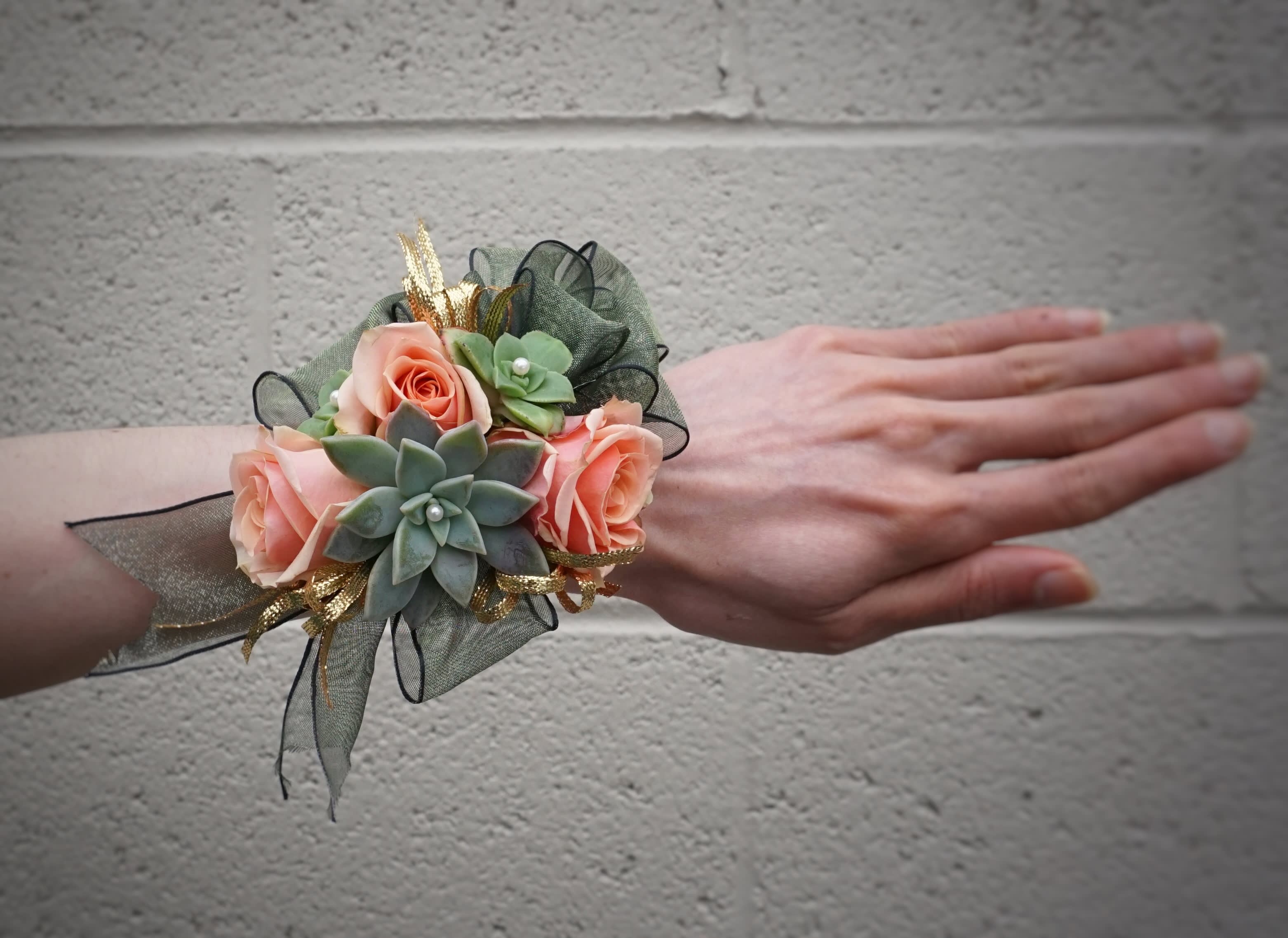 Wrist Corsage 25 - Wrist corsage with roses, succulents and accents. STANDARD AS SHOWN: WRIST CORSAGE DELUXE: WRIST CORSAGE + BOUTONNIERE