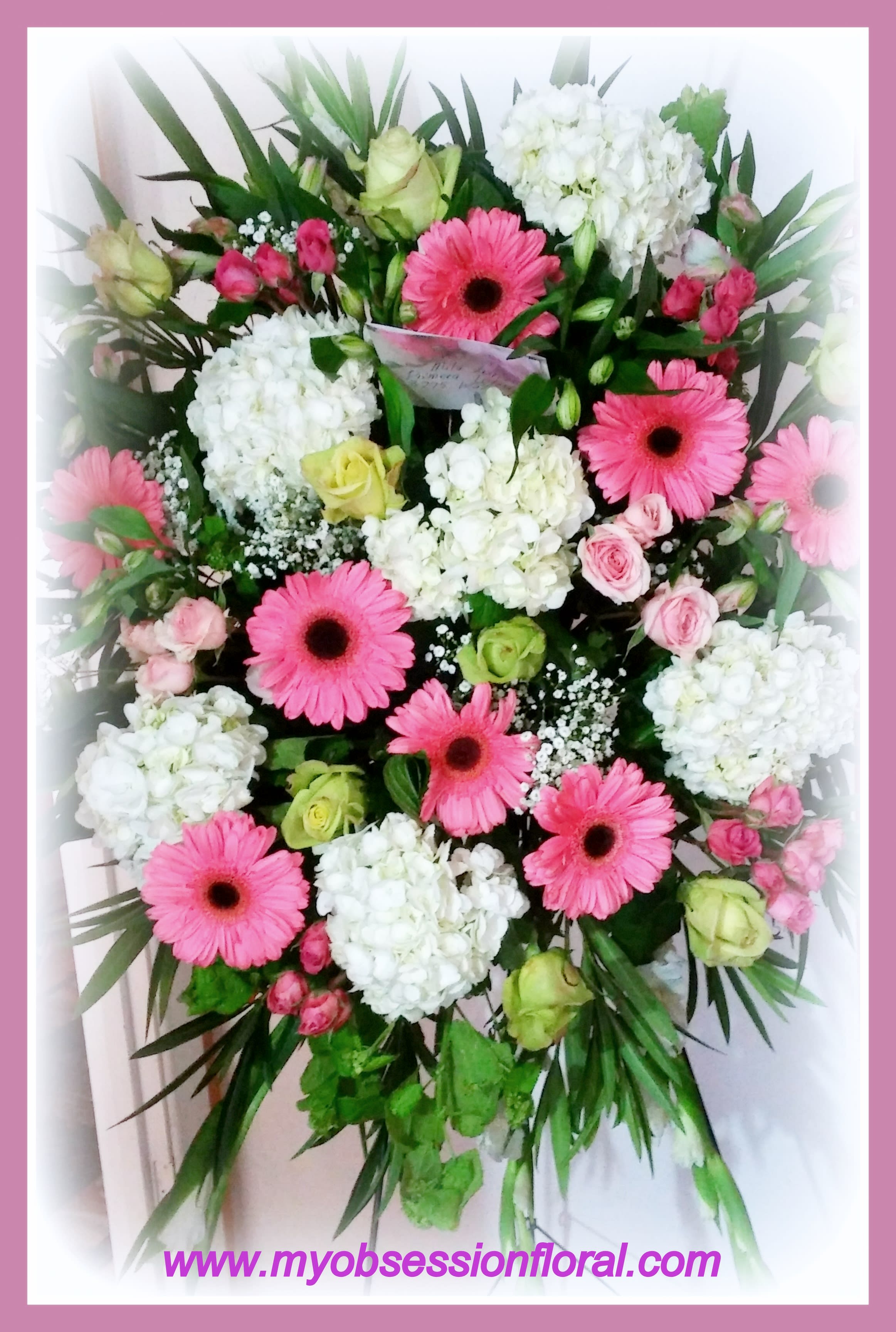 Pink and peach gerberas spray. - If you like gerber daisies, order this fresh floral spray of roses, gerberas, and hydrangea. This is a sympathy arrangement for service or home floral delivery.