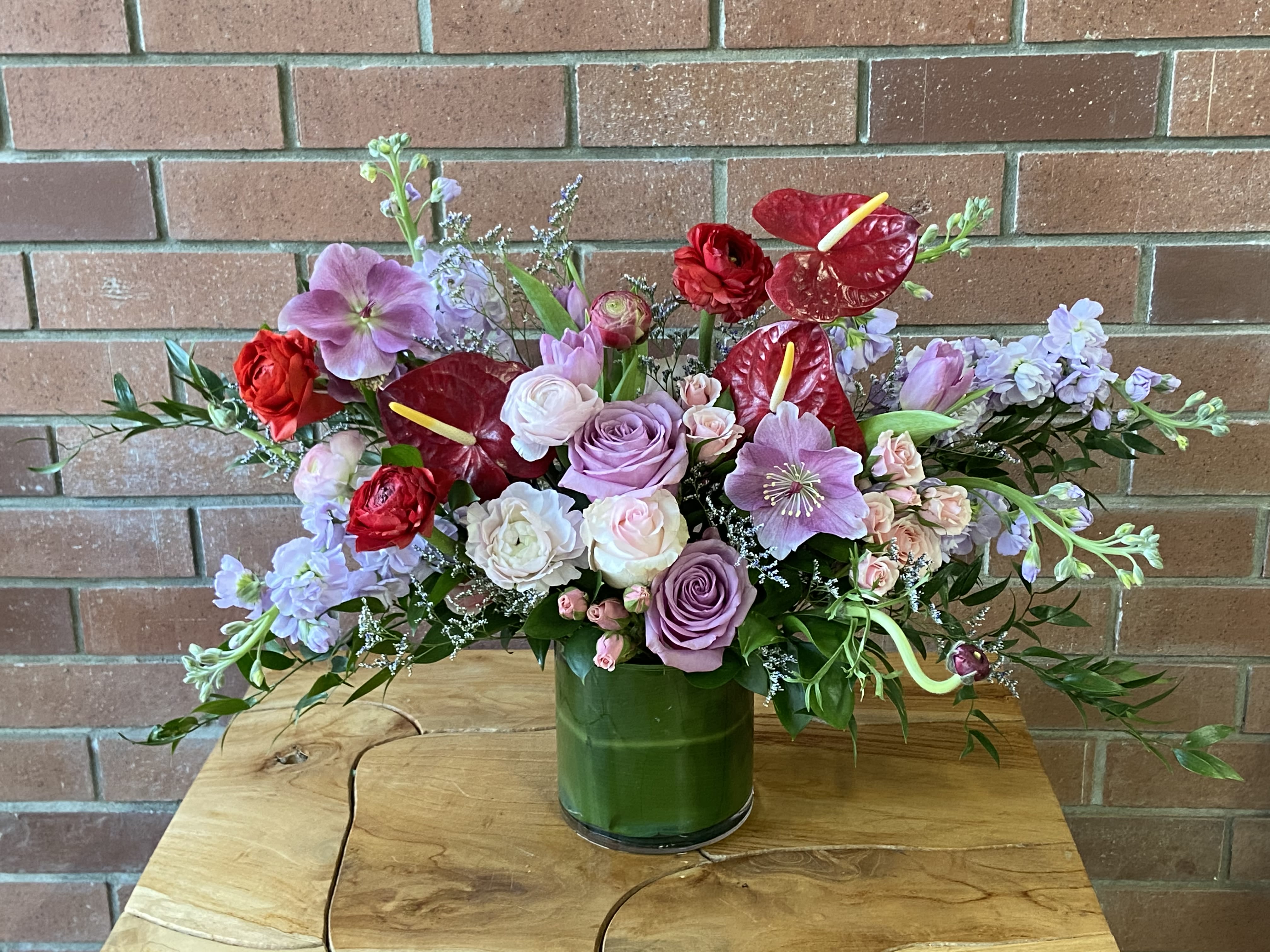 It's Her Happy Day Bouquet - A wonderfully romantic bouquet full of lush greens, roses, scented stock, hellebores, and other wildflowers to make her day!