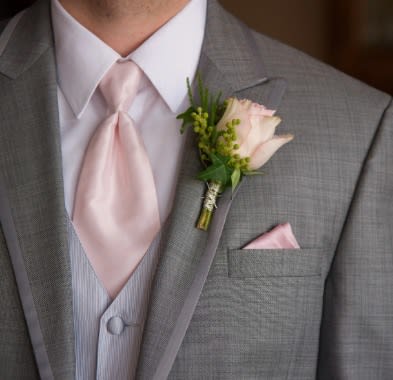 Boutonniere   - A classic boutonniere featuring a rose as the centerpiece.