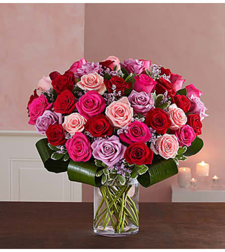 Lavish Love Bouquet - Let her know your love is forever with a sensational surprise she’ll remember forever! We’ve hand-arranged 50 timeless roses in striking shades of red, pink and lavender inside a stylish cylinder vase for the ultimate romantic gesture. And because one amazing gift deserves another (and another…and another!), pair these gorgeous blooms with our huggable plush bear, decadent chocolates and “I Love You” balloons!