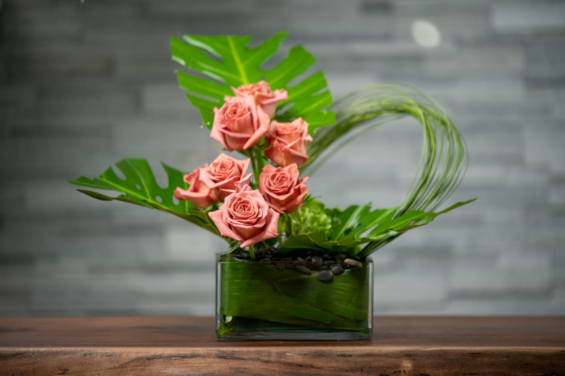Barista - Minimalist and modern combination of terra cotta roses, looping grasses and tropical leaves.