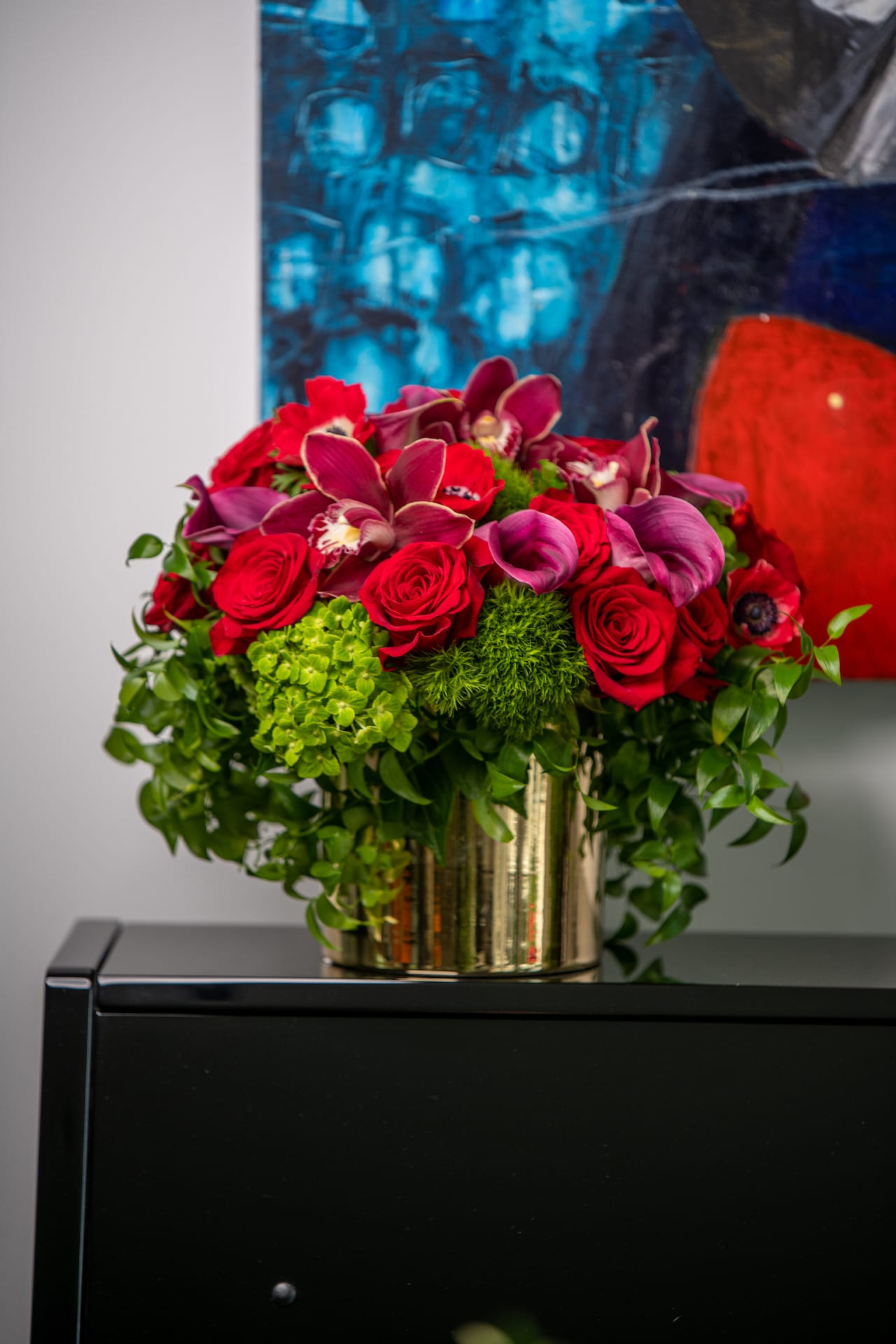Grateful - Rich and elegant yet organic and natural. Smilax vine grapes gently around roses, hydrangea, anemone and orchids.